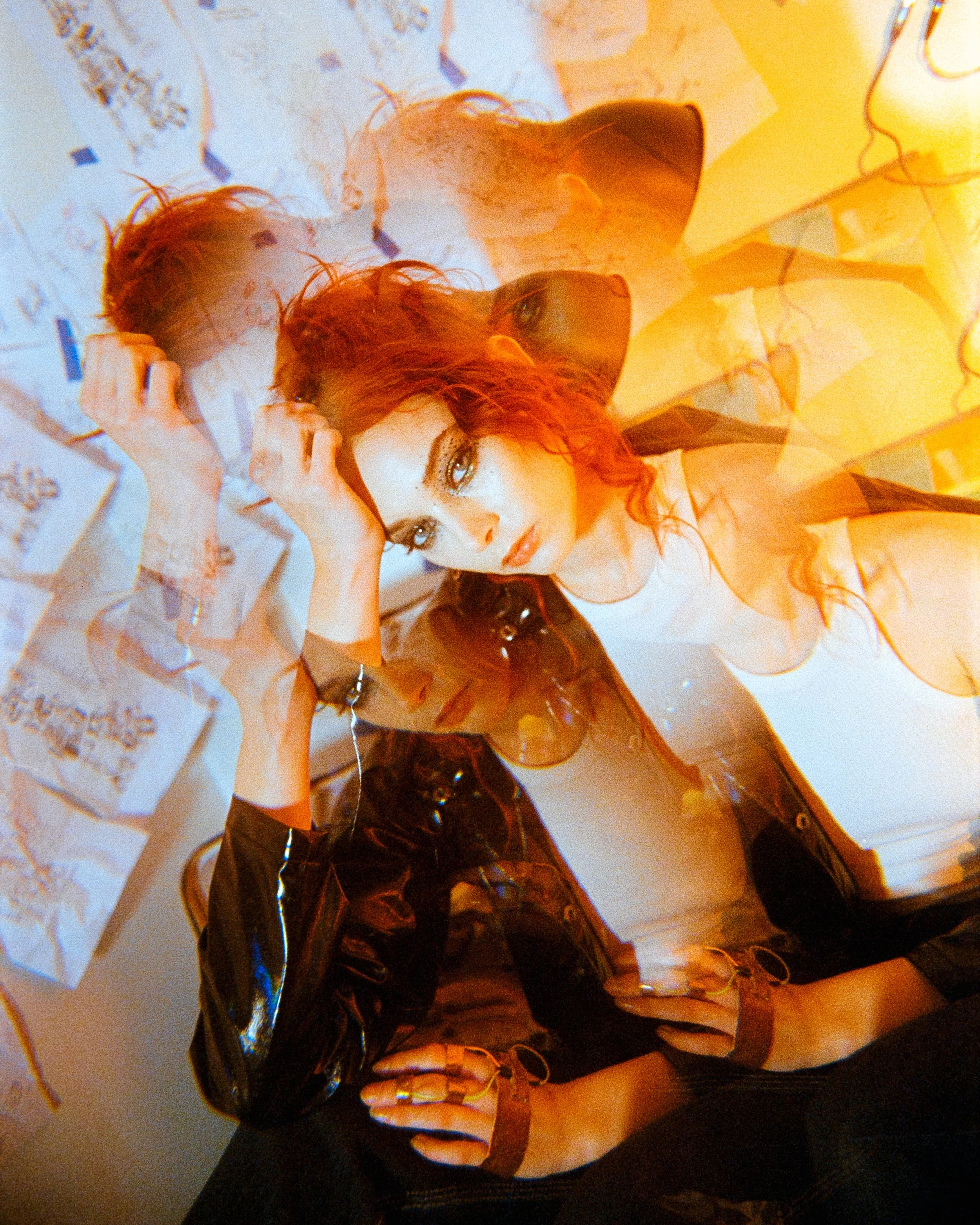 Multi image of a woman looking at the camera, her orange hair vibrant and glowing, her eyes piercing, hand on her head, thinking seriously, on 35mm Film - Ultramax