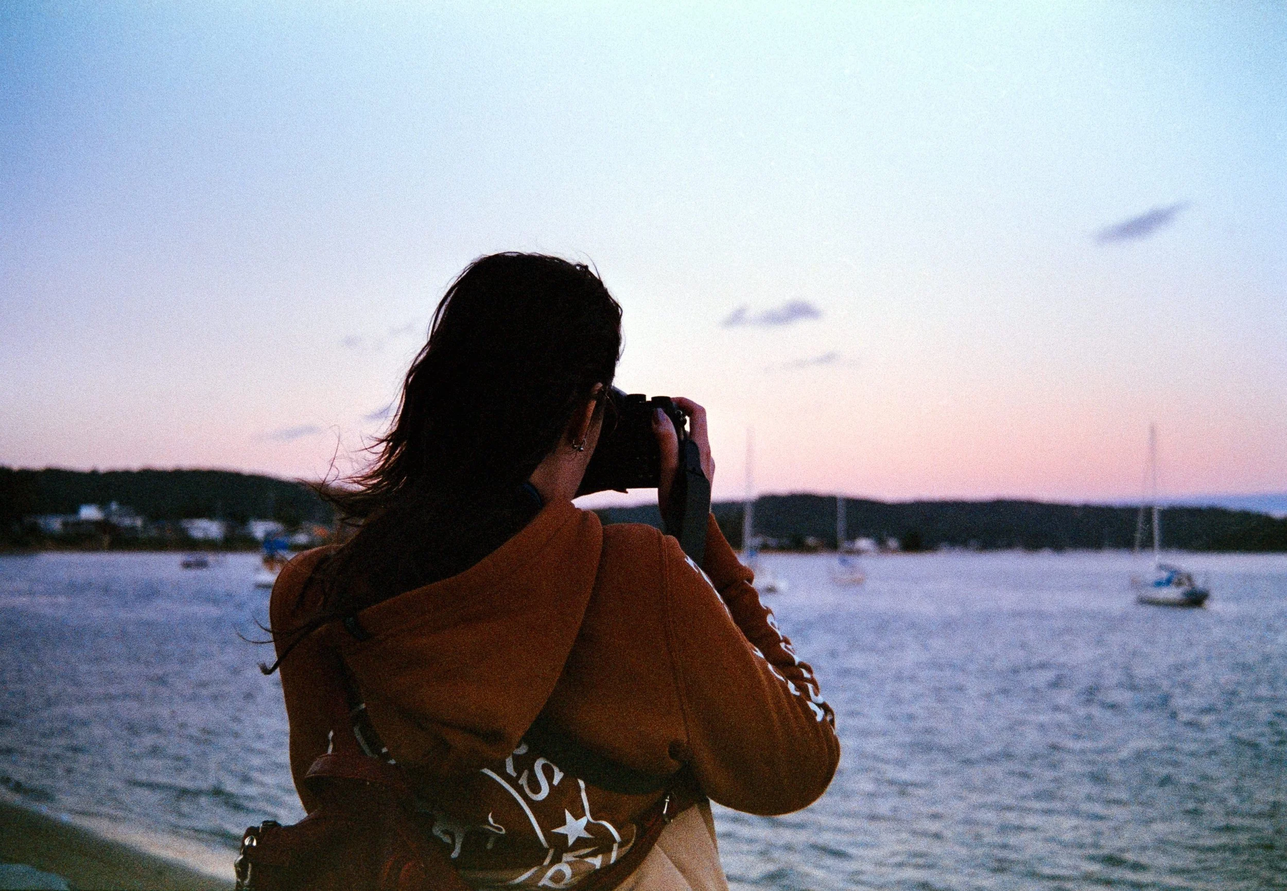 Josie capturing a sunset with her Ricoh film camera, on 35mm Film - Ultramax