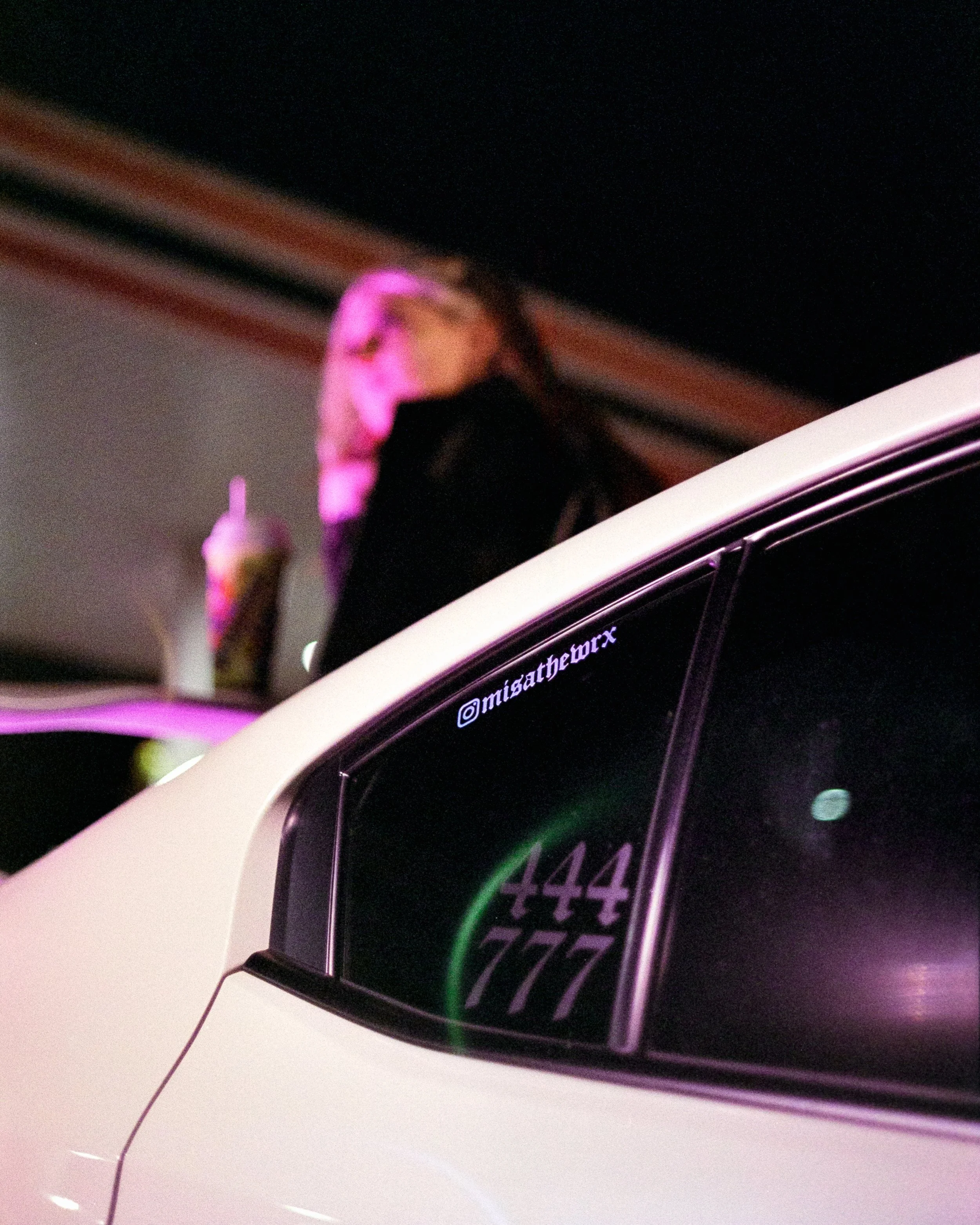 A close up of angel number stickers on Melody's car, 444 and 777, shot on 35mm Film - Ultramax