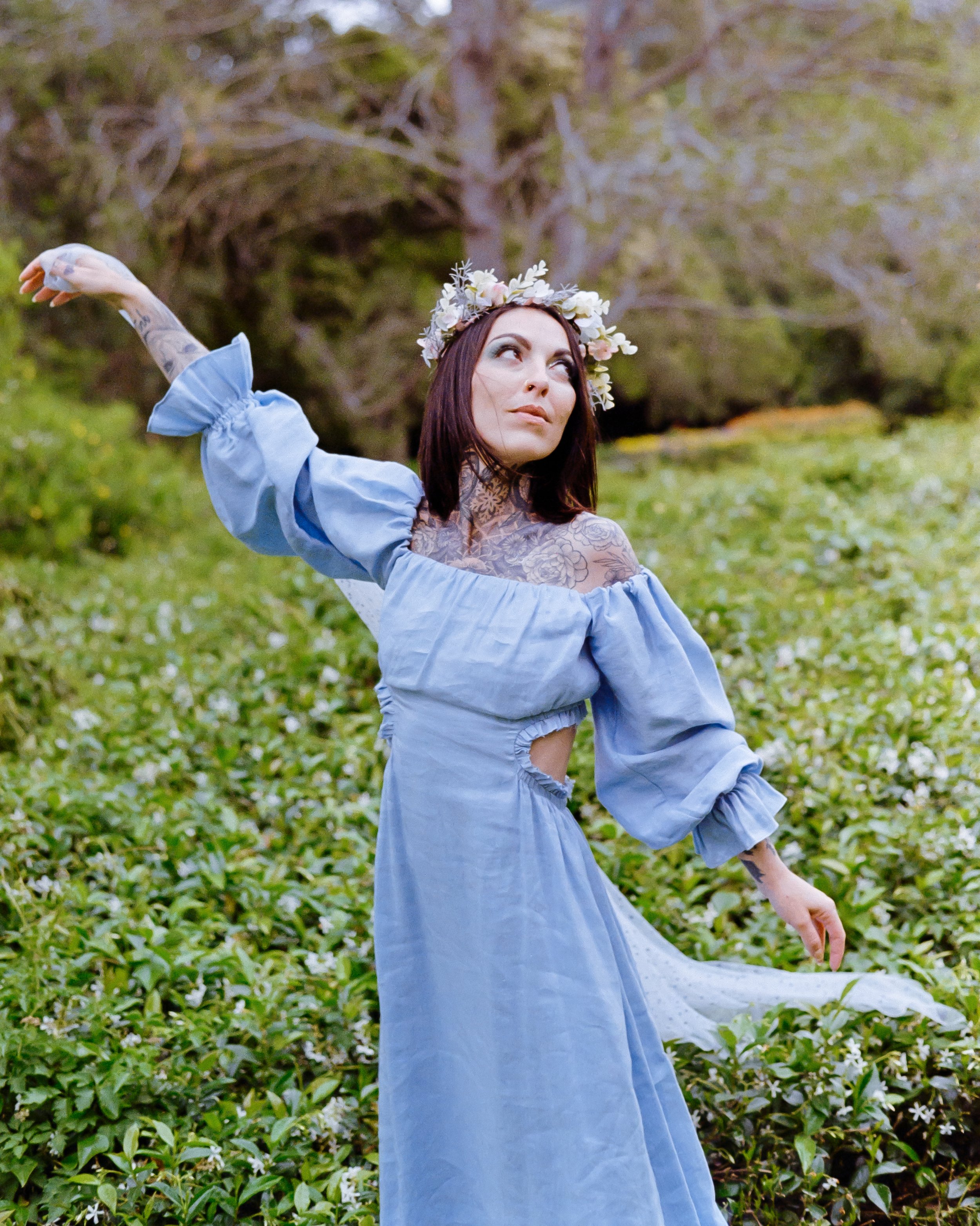 alternative cinderella in a flower park, holding a veil that is blowing in the wind, a flower crown on her head, on 35mm Film - Pro Image 100