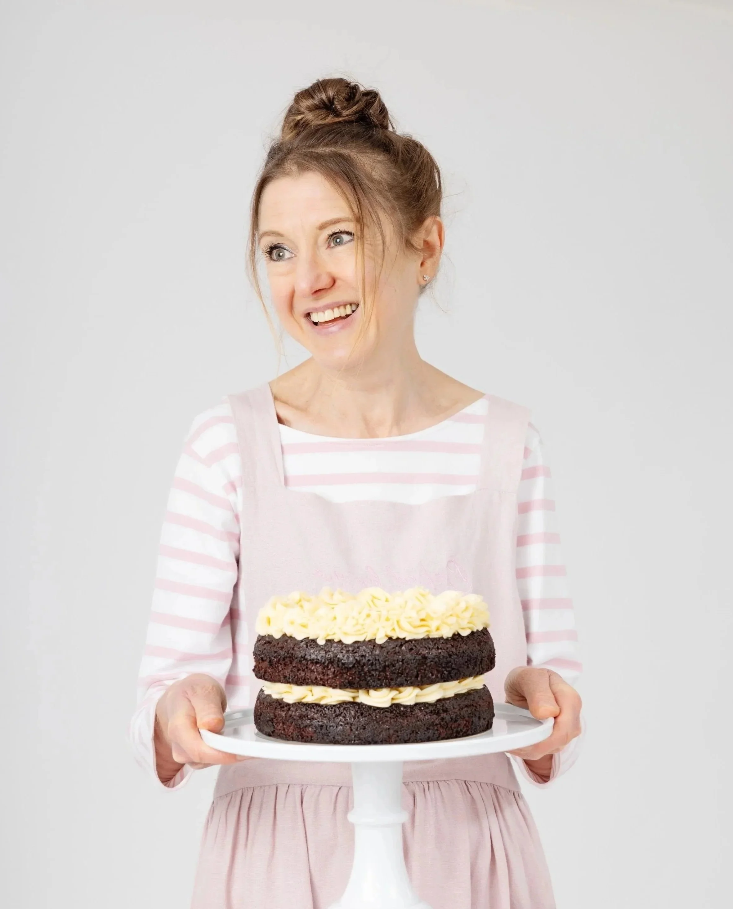 Owner of Baked by Me for You, a home bakery in Horsforth, holding a chocolate cake.