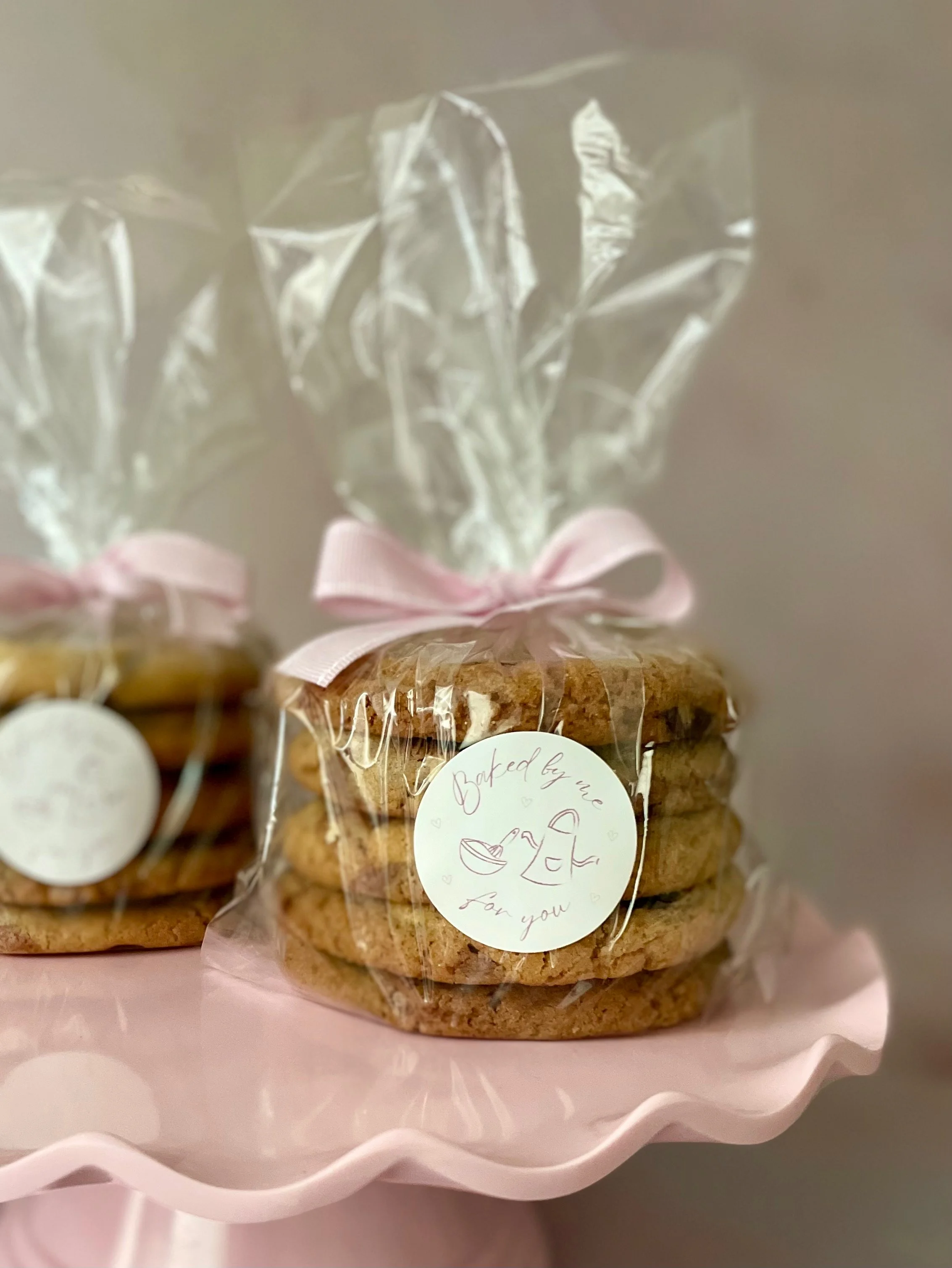 Chocolate chip cookies in gift bags tied with pink ribbon.JPG