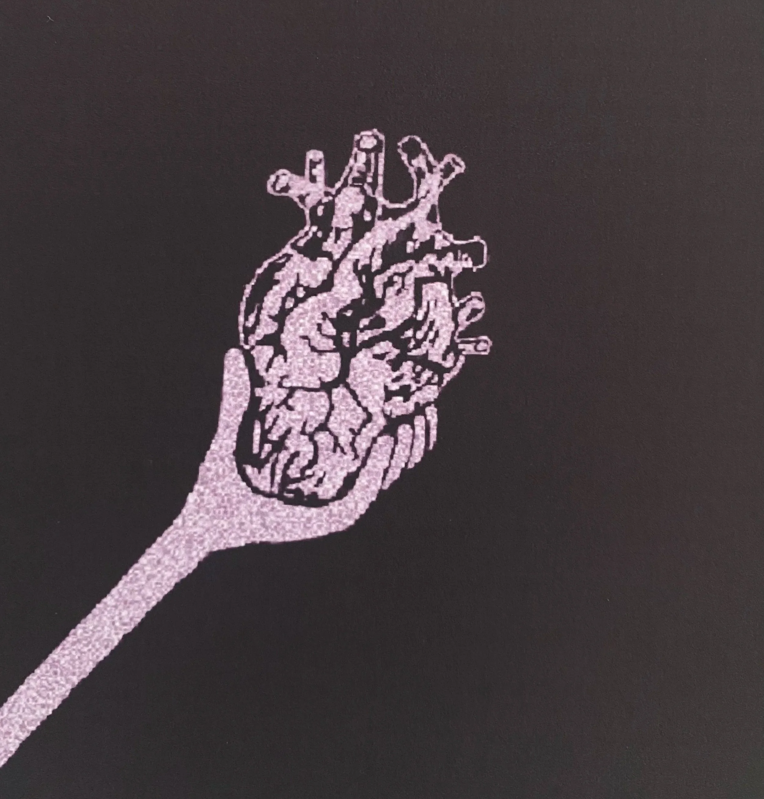 light purple human heart with a hand holding it, set against a dark purple background.