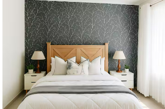 A bedroom with a wooden bed frame, white bedding, and two matching nightstands with lamps. The wall behind the bed has dark wallpaper with a white tree branch pattern, and there are white curtains on the right side.