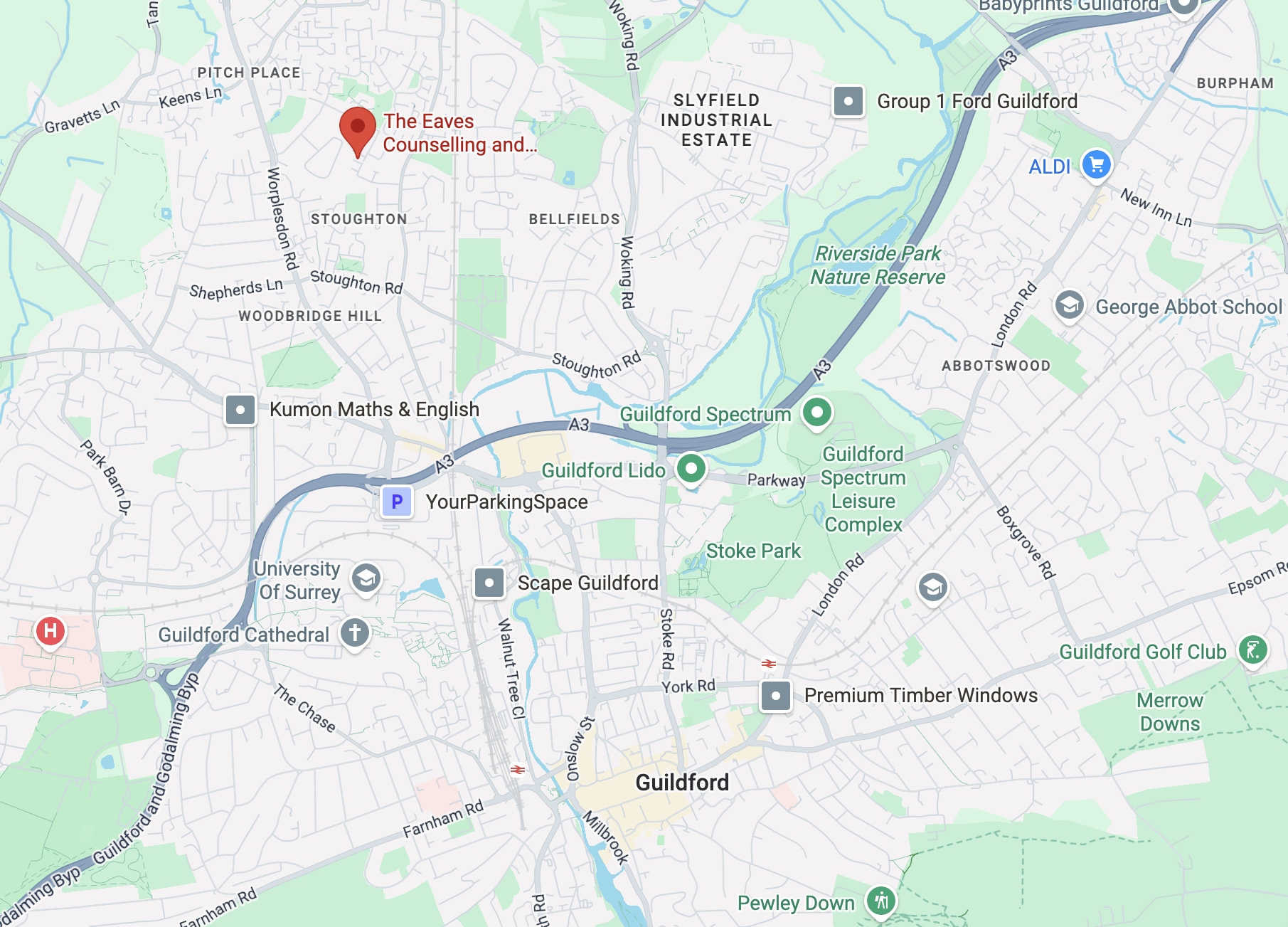 Map of Guildford, highlighting landmarks such as Guildford Spectrum, Guildford Lido, Stoke Park, University of Surrey, and Guildford Cathedral, with various roads and parks.