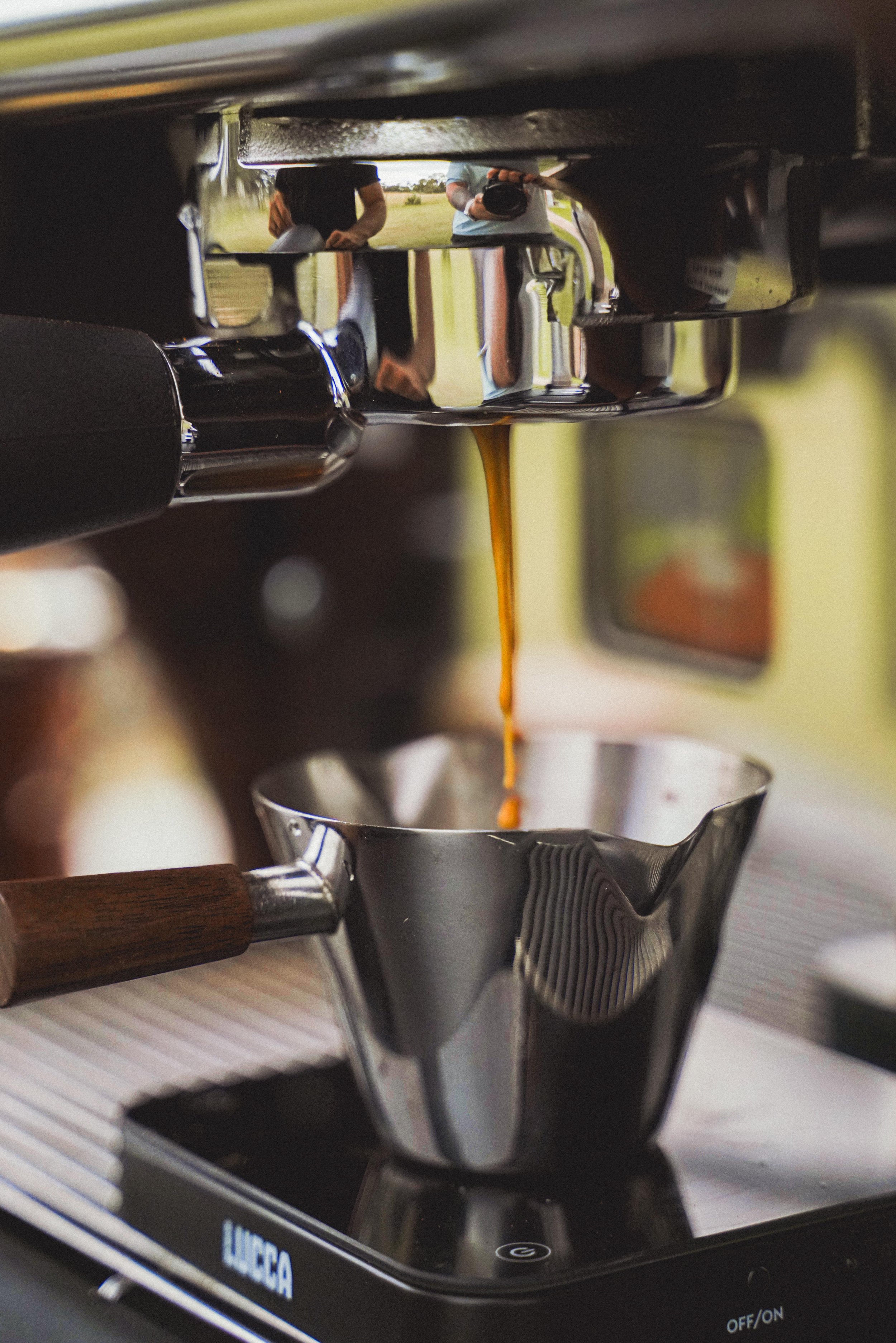 Espresso extracting into shot cup