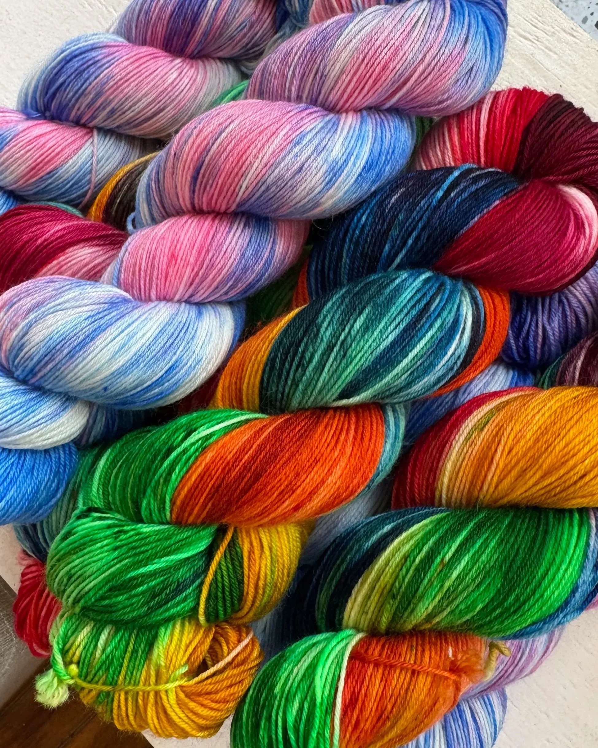 Colorful skeins of yarn with rainbow and and pride multicolored patterns