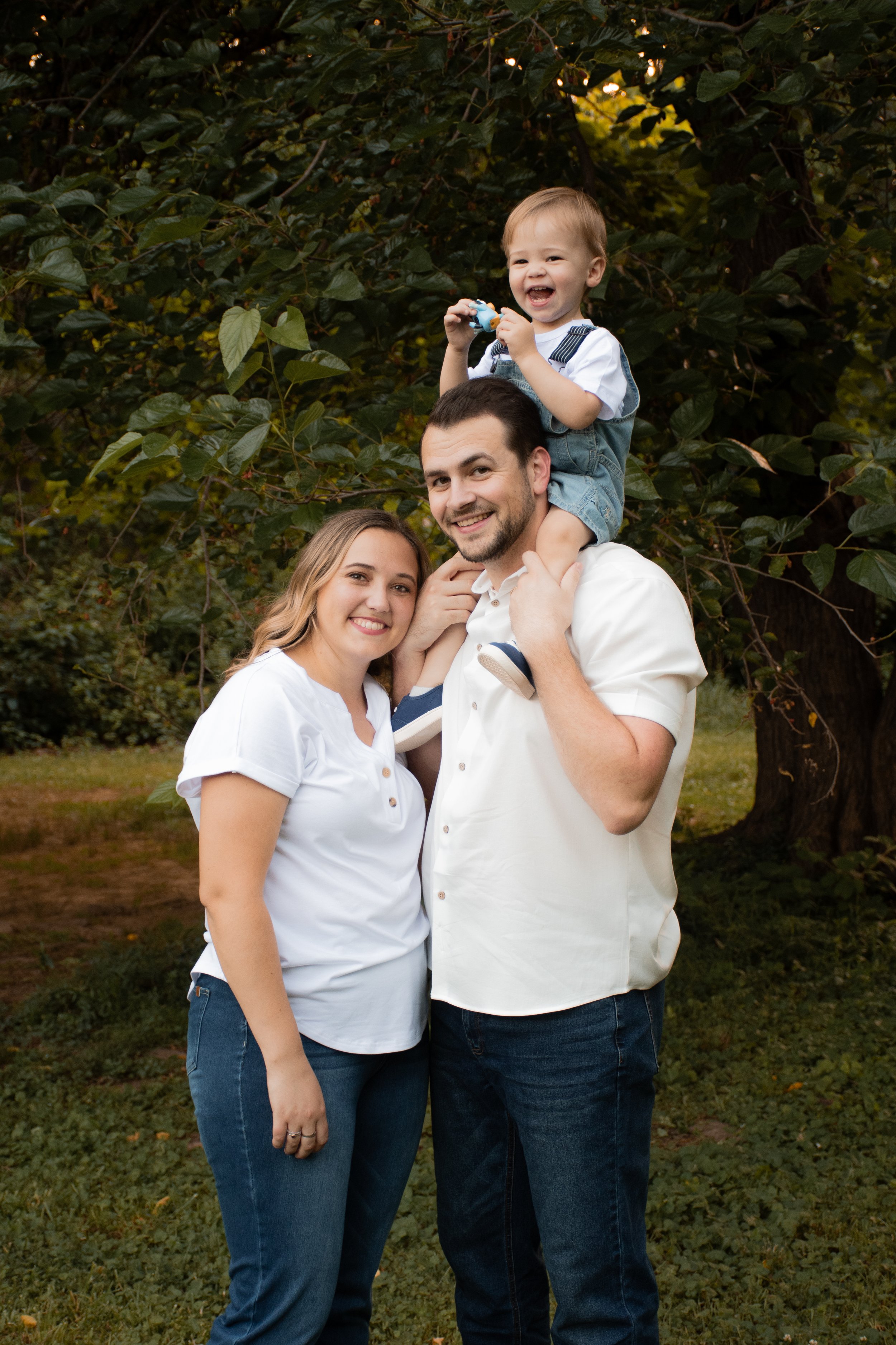 Parents with their toddler on the father's shoulders