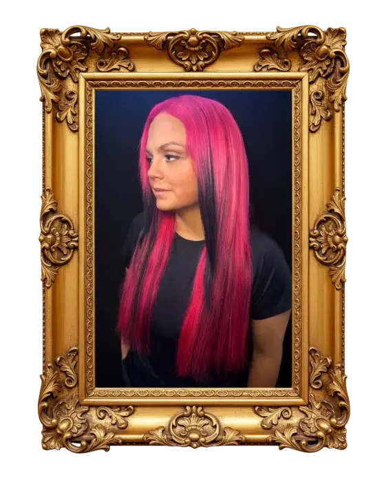 A woman with long, straight pink hair framed by a gold ornate picture frame.