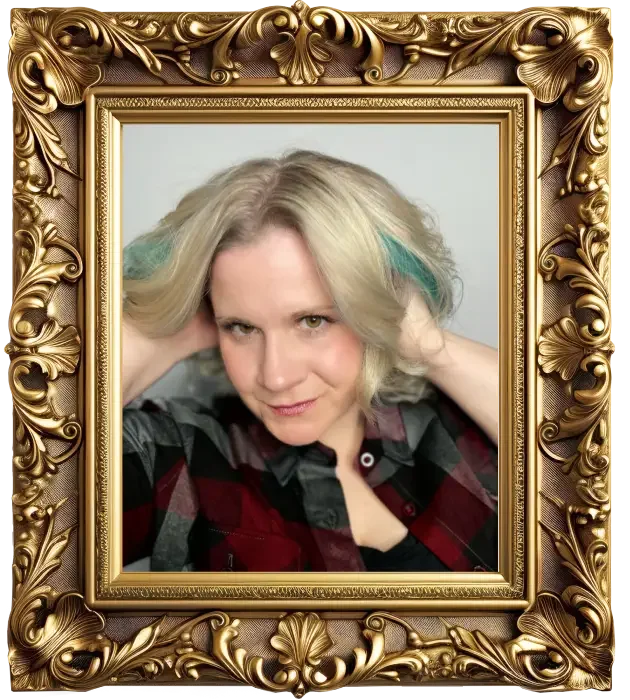 A woman with blonde hair and green streaks, wearing a black and red plaid shirt, posing with her hands behind her head inside an ornate gold frame.