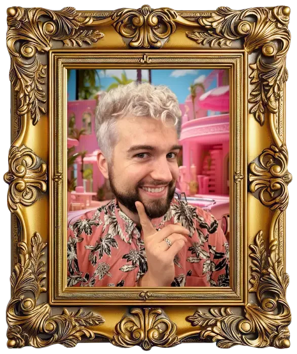 A man with curly blonde hair and a beard smiling and touching his chin, posed inside a decorative gold frame with a pink and tropical background.