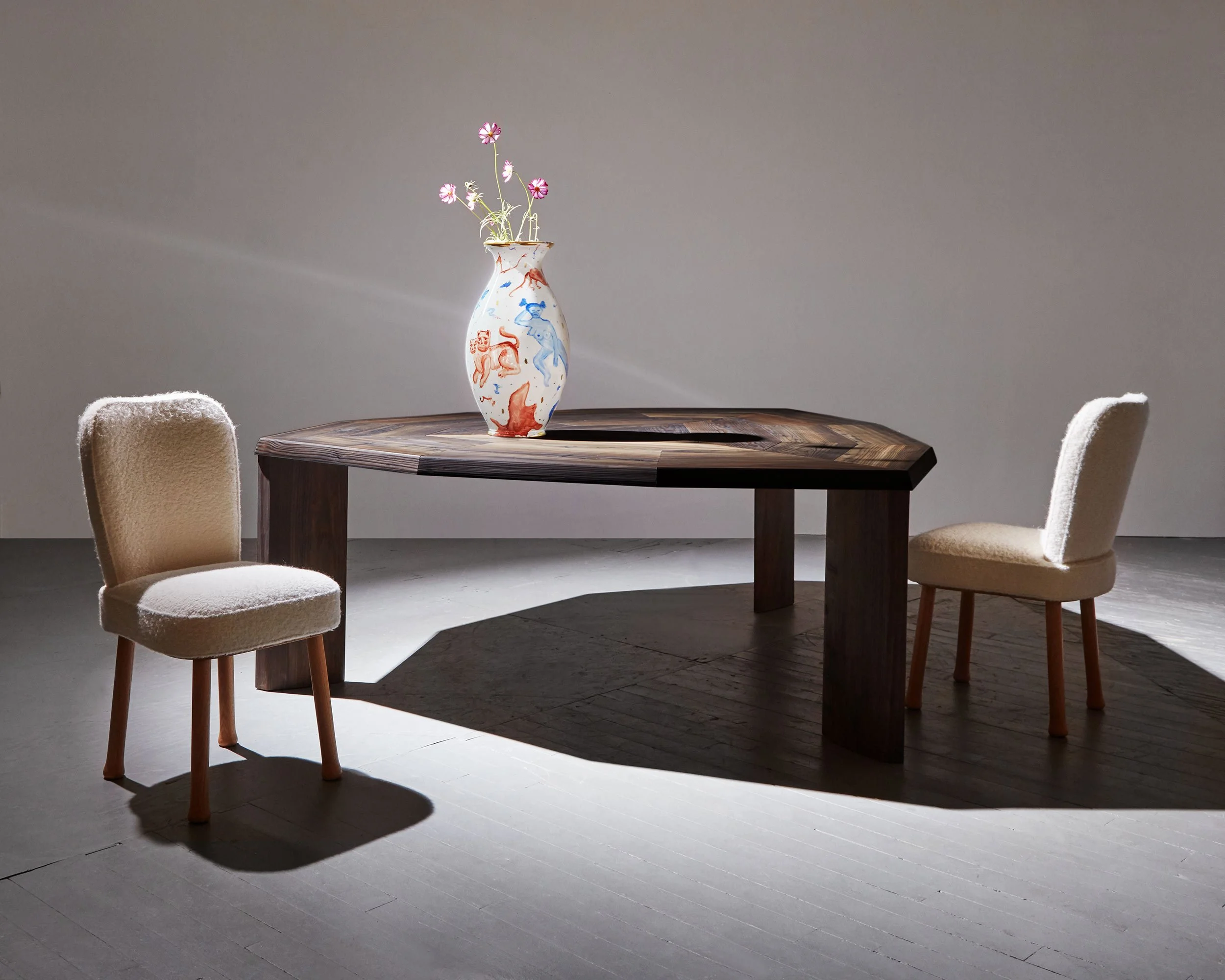 Marketing vignette of the Rochefort dining Table and chairs by Pierre Yovanovitch, hand painted ceramic vase by Katy Stout, shot for R & Company design gallery, NYC