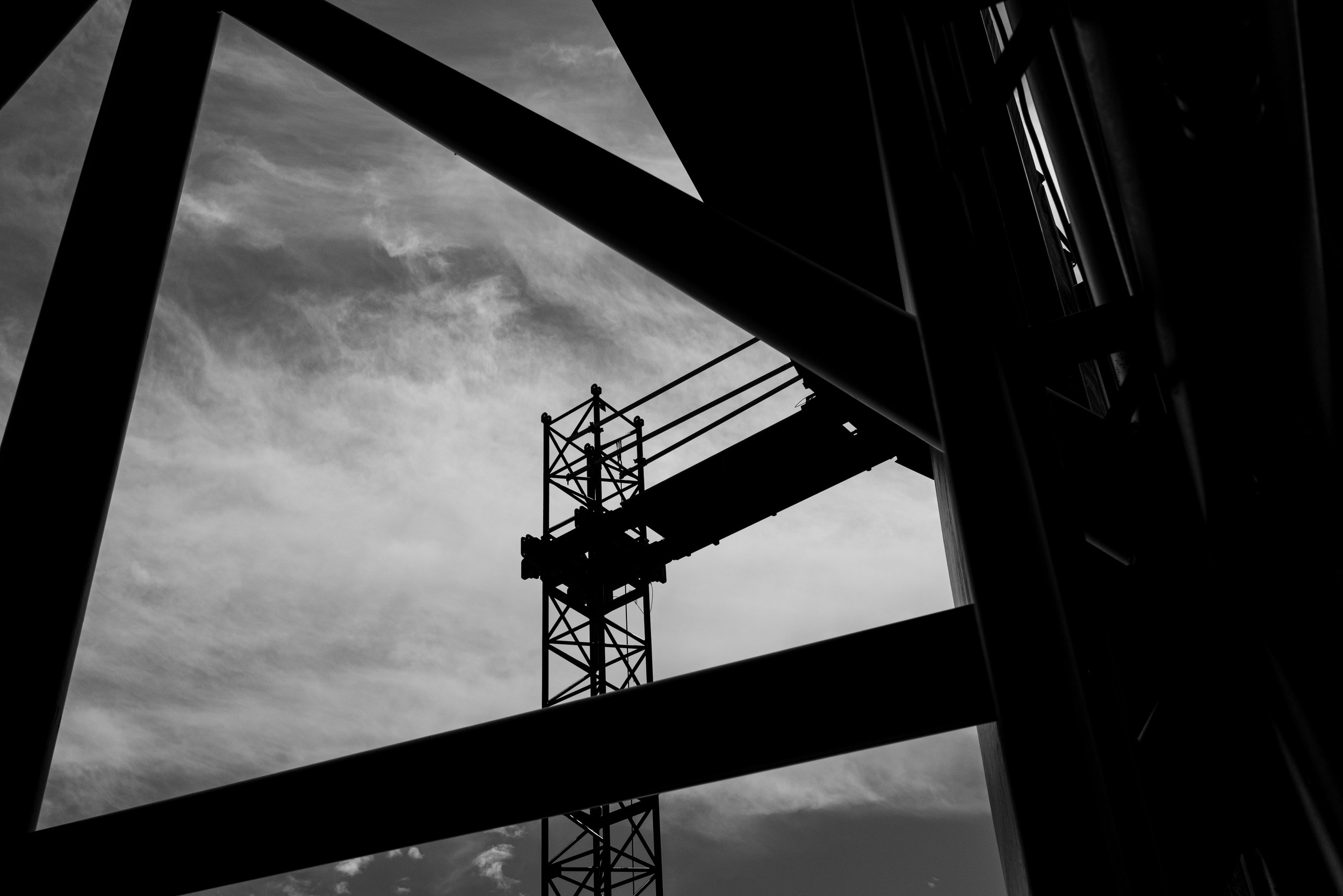 Black and white photo of a stage and cloudy sky in the background.