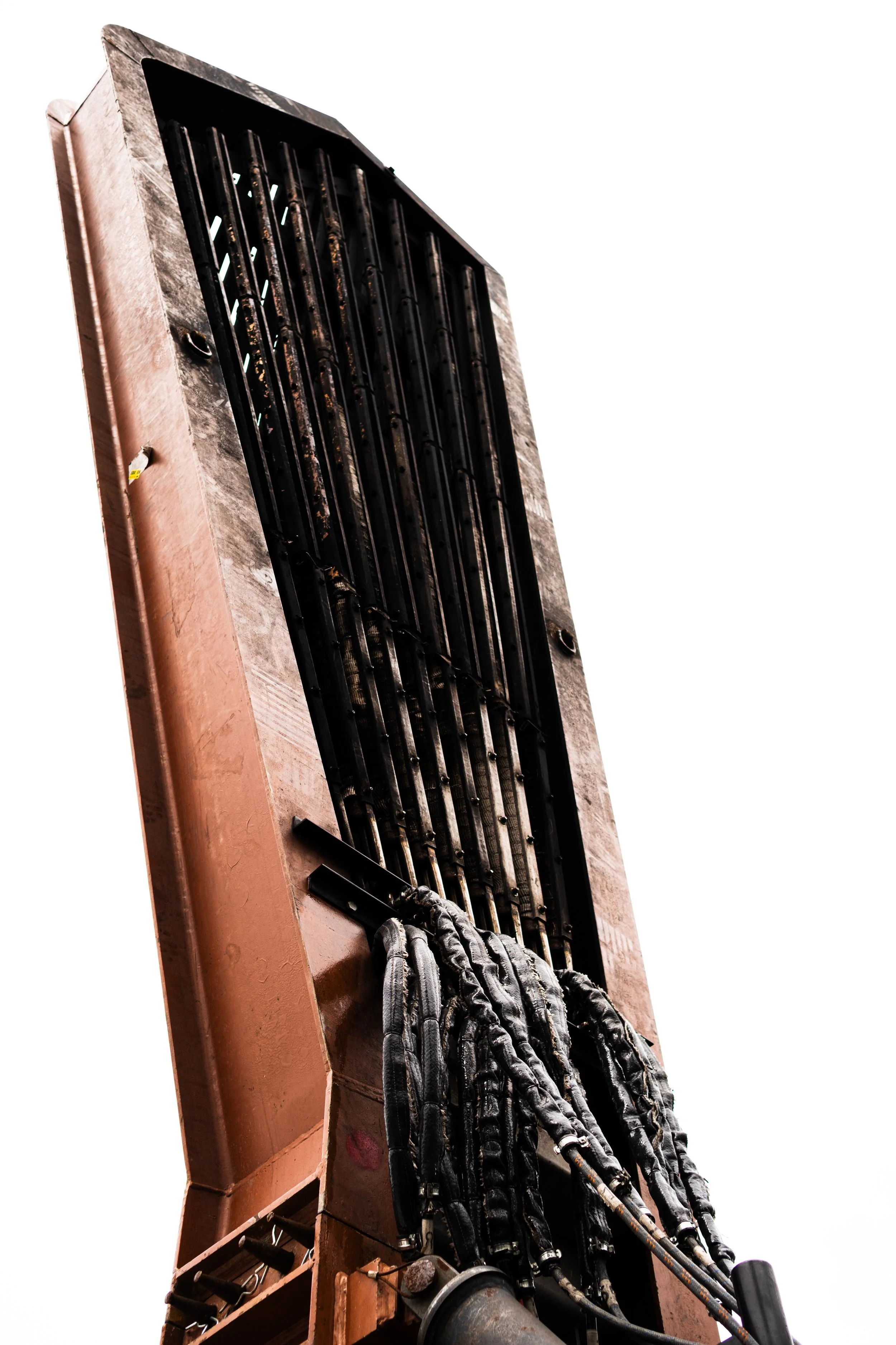 Close-up of the interior of a smoke grenade, showing the black fuse wires connected to a metal structure inside a red plastic shell.