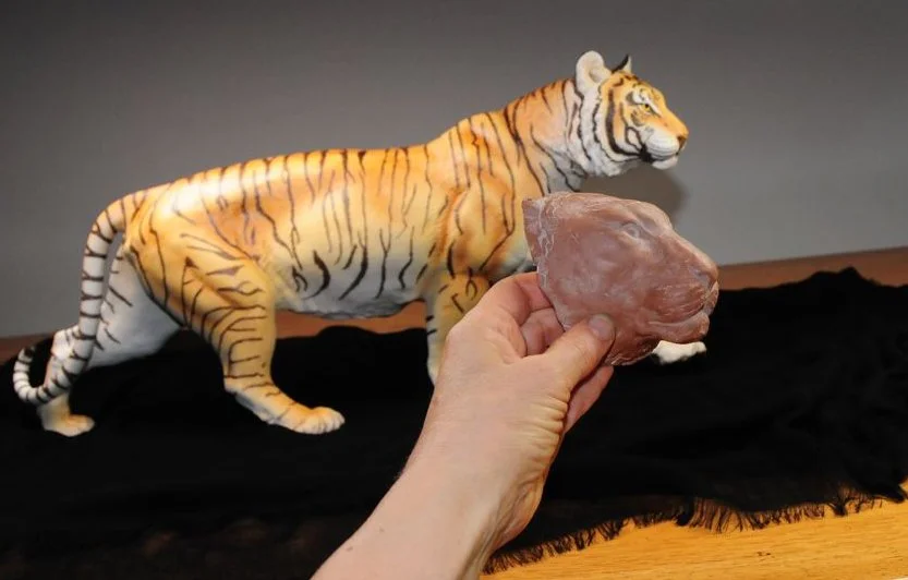 The Bengal Tiger, a large, beautifully hand-painted porcelain sculpture, has a storied history. It was originally sculpted in clay by Chuck Oldham, but when the Franklin Mint first marketed it, they placed another artist's name on the piece (yes, the