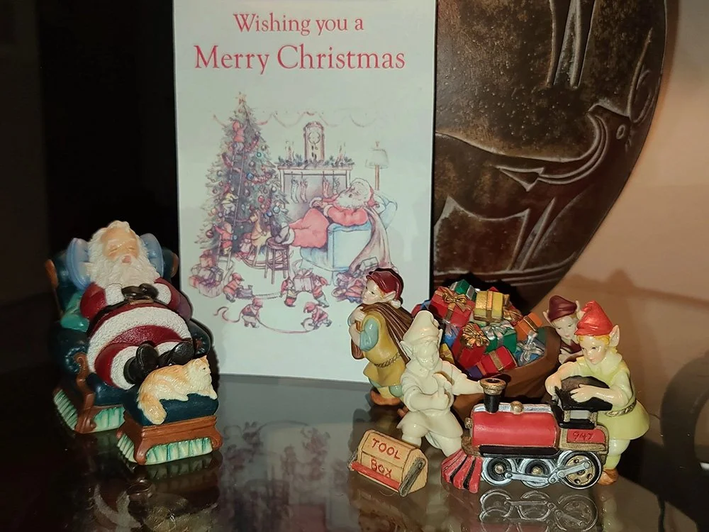 Chuck and Vicky Oldham created an entire figurine collection of lazy Santa and hard-working elves to accompany an original Christmas card sketched by Vicky in the late 1990s.
