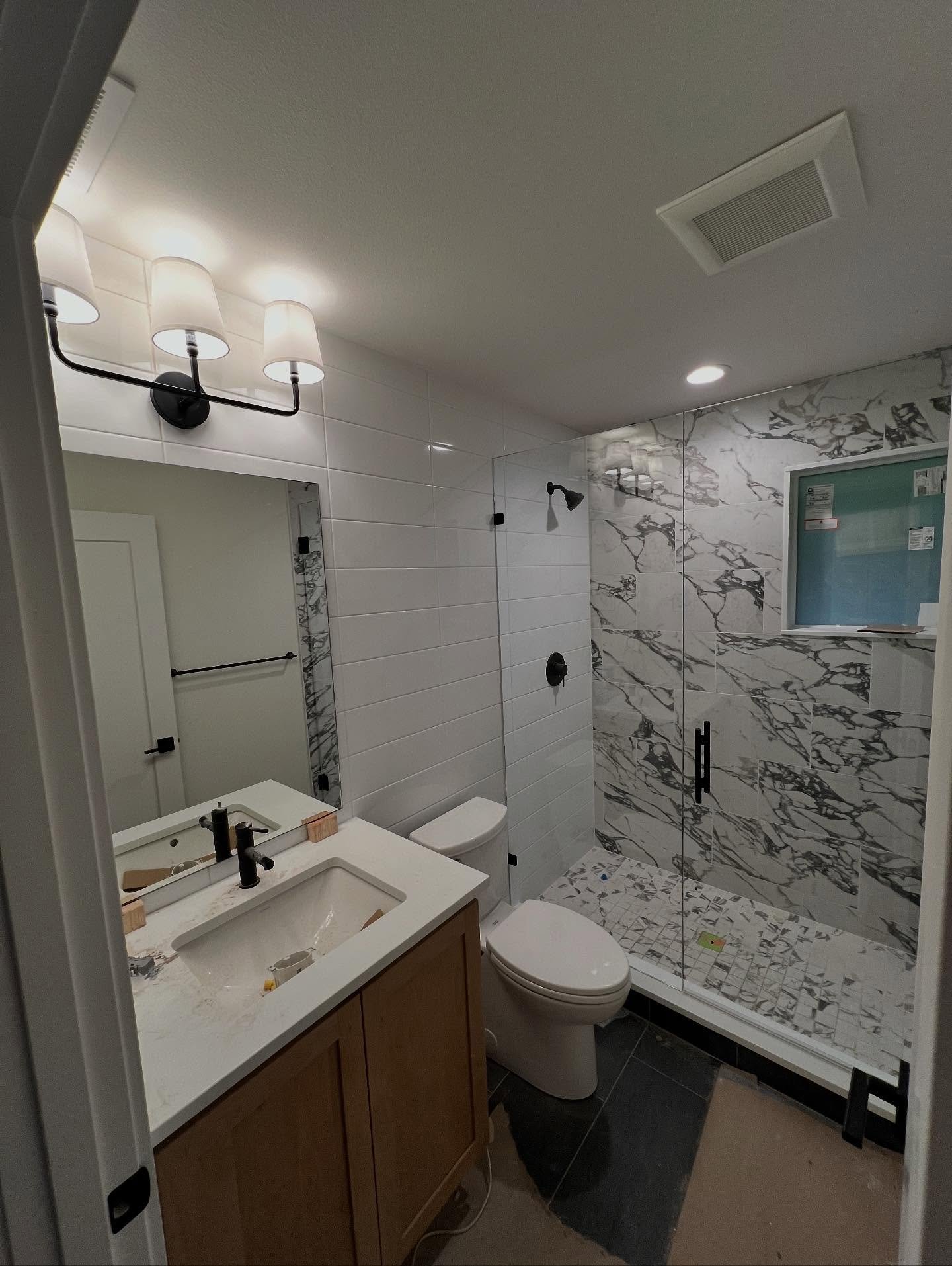 Frameless Shower and Mirror with Matte Black Hardware.

#framelessshowerglass #framelessshower #seattleshowerdoor #seattleshowerglass #showerglass #showerdoor #seattleglasscompany