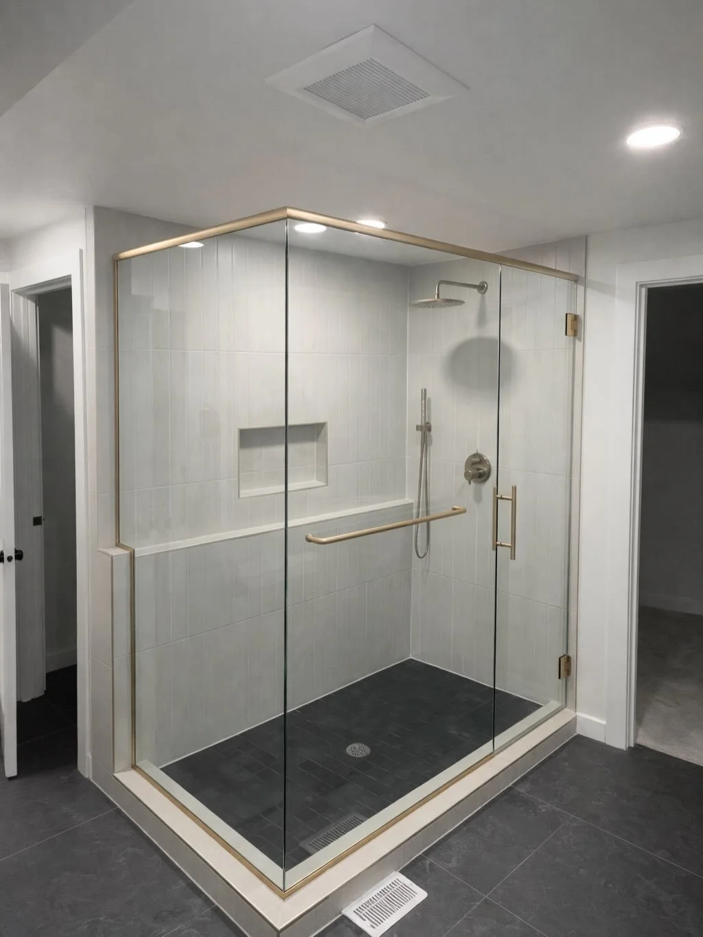 Three Panel Enclosure with Satin Brass Hardware #bellevueglasscompany #seattleglasscompany #framelessshower #showerglassenclosure #smallbusiness