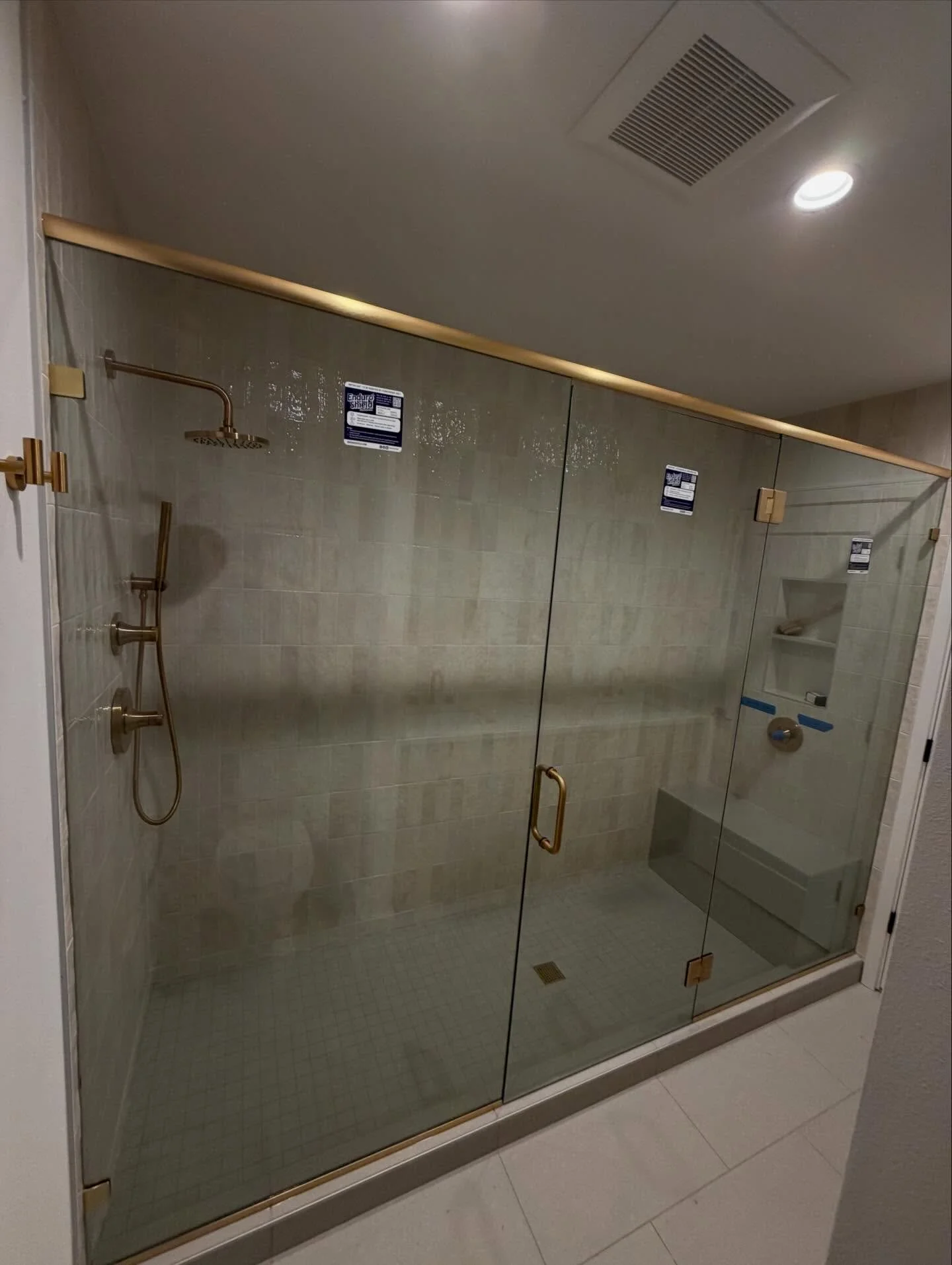 Three Panel Inline Shower Glass enclosure with Satin Brass Hardware #showerglass #seattleglasscompany #bellevueglasscompany #showerglasscompany #familyowned