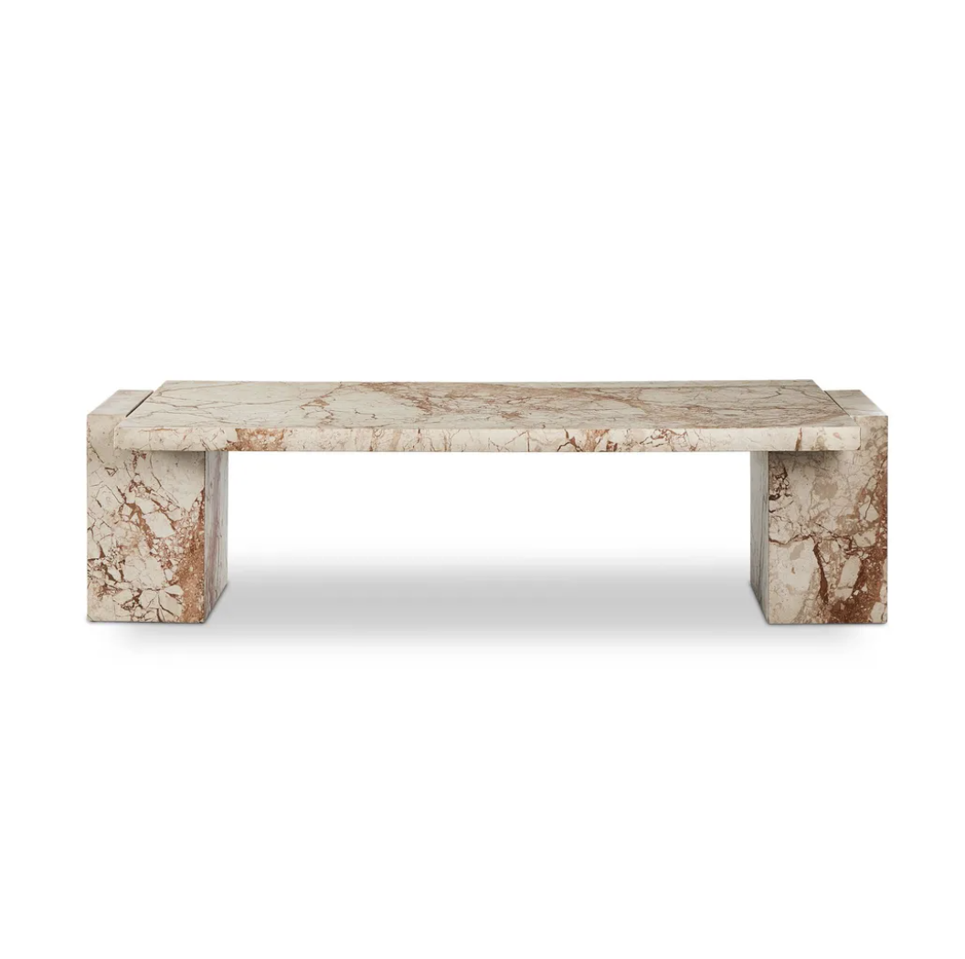 A rectangular marble bench with a beige and brown veined pattern, supported by two large block legs on either side.