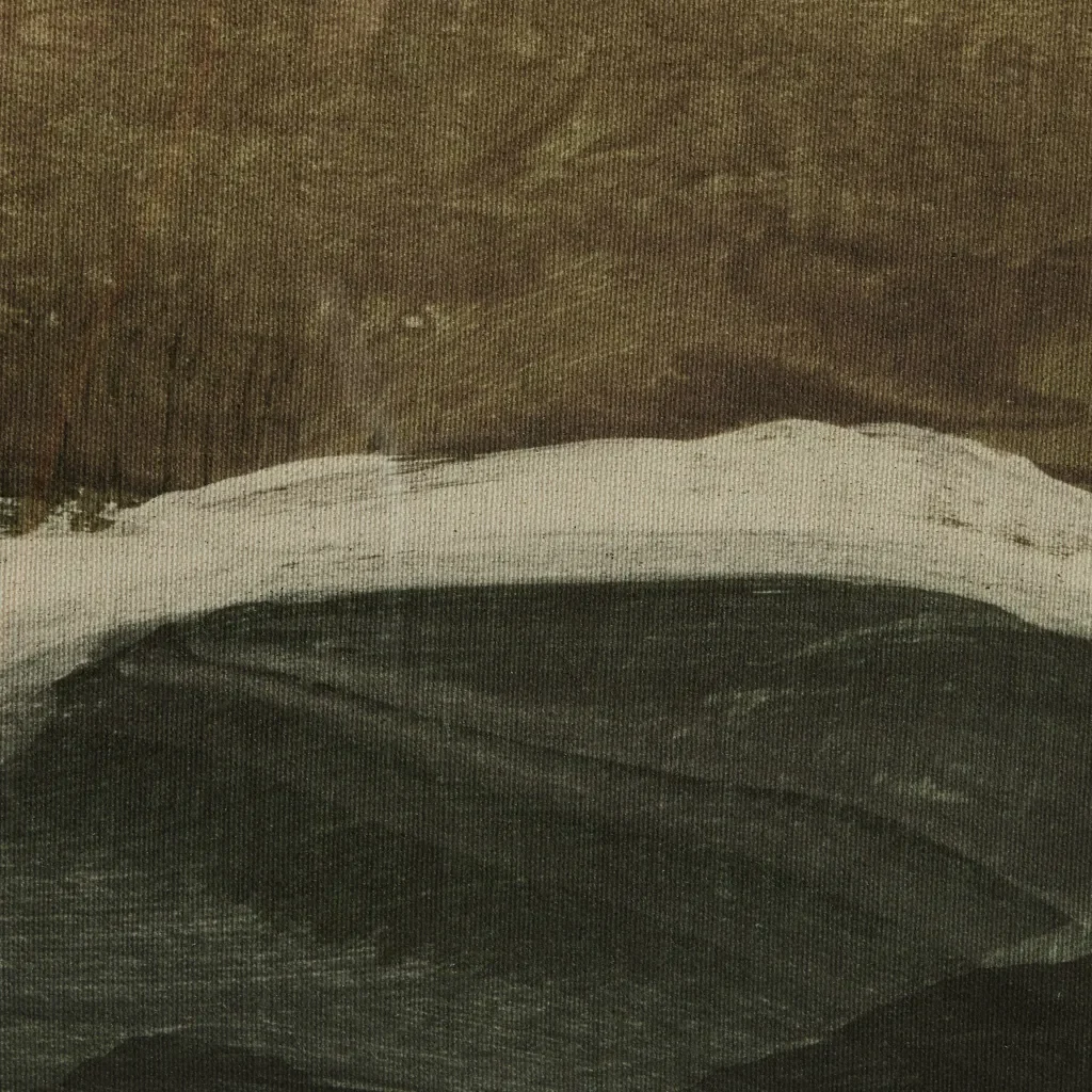 Close-up of a textured surface with layers of paint in brown, white, and black.