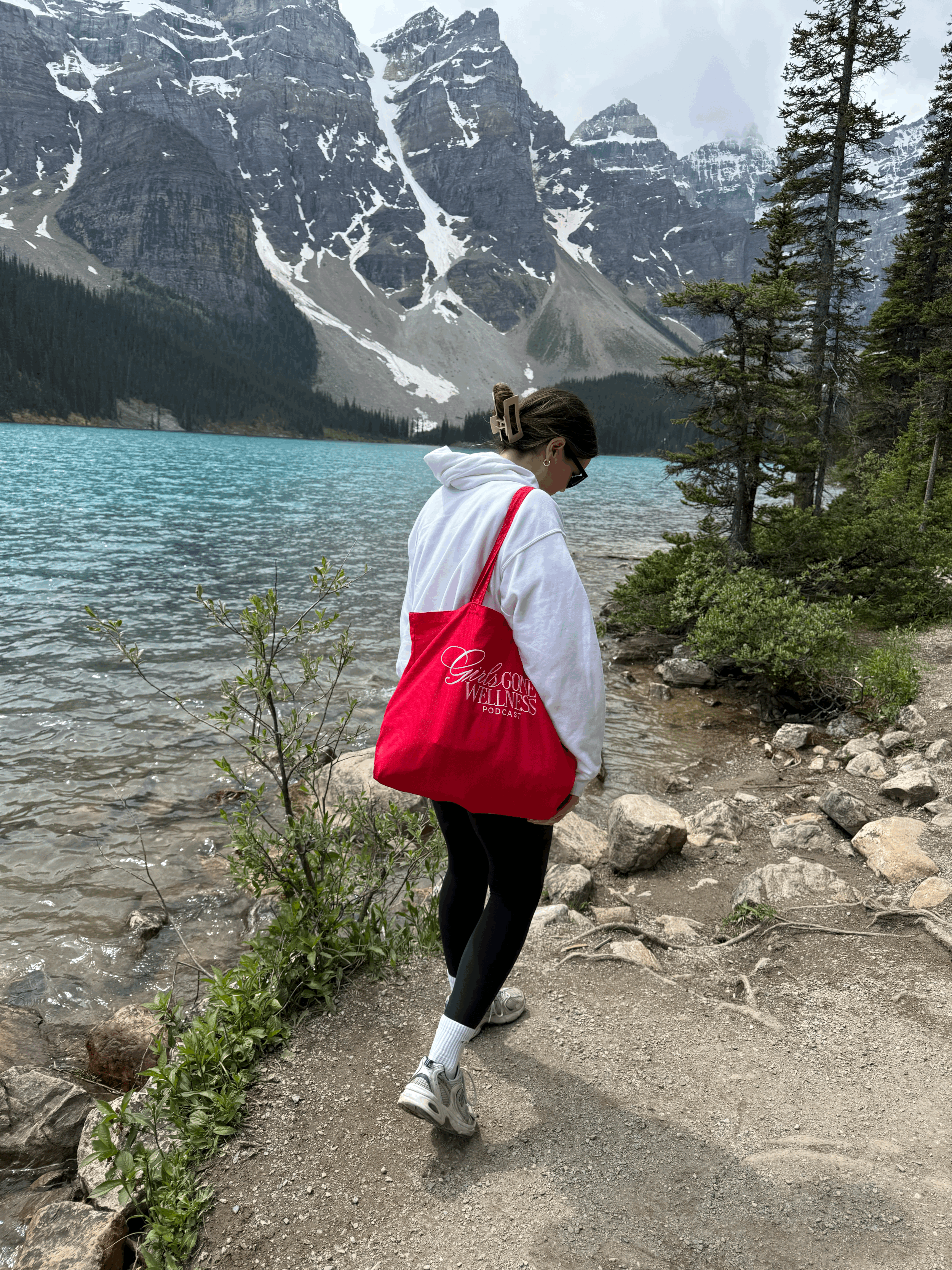 Girl carrying red wellness tote bag on a hike