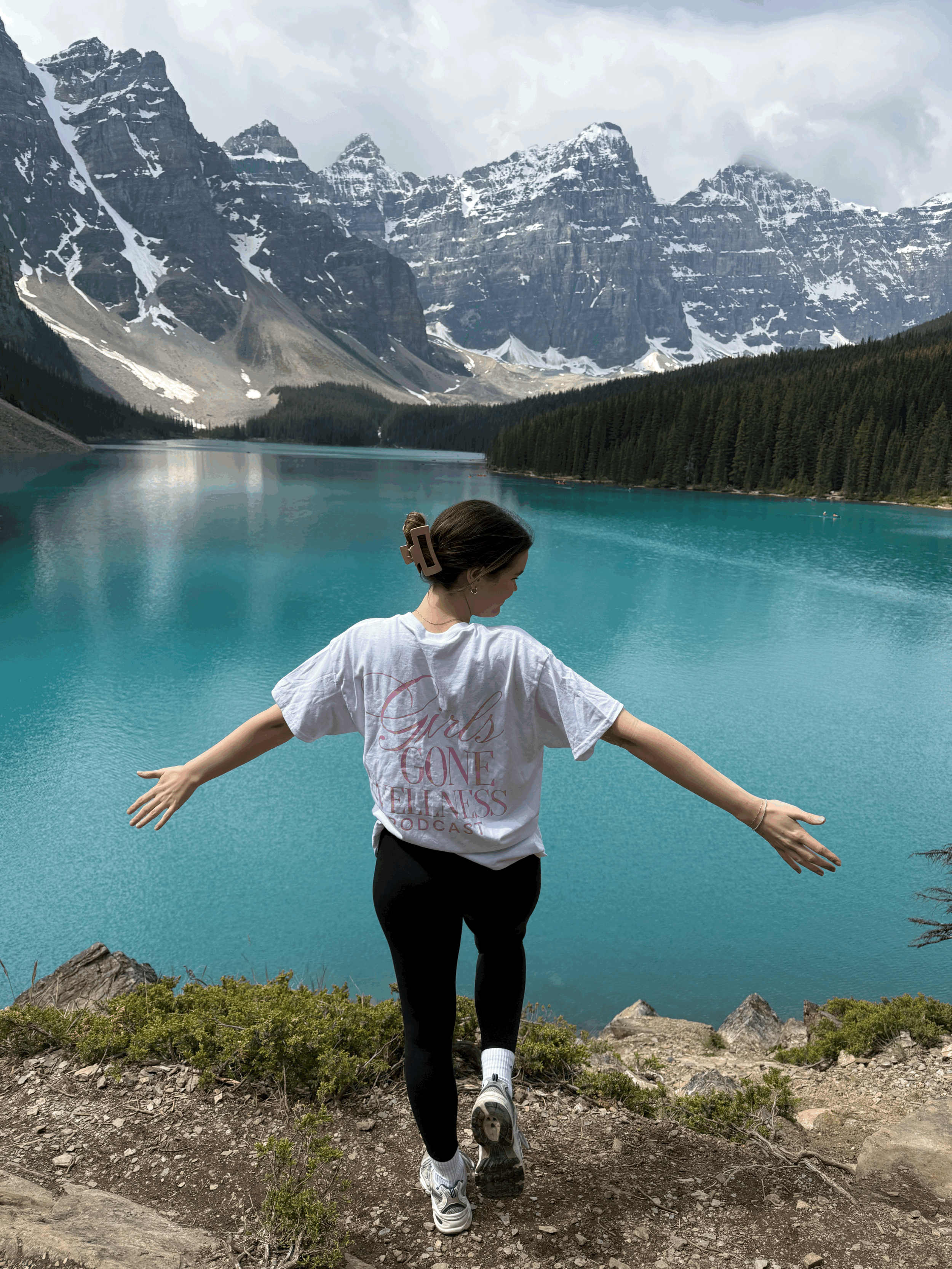 Girl wearing White wellness t-shirt with pink writing