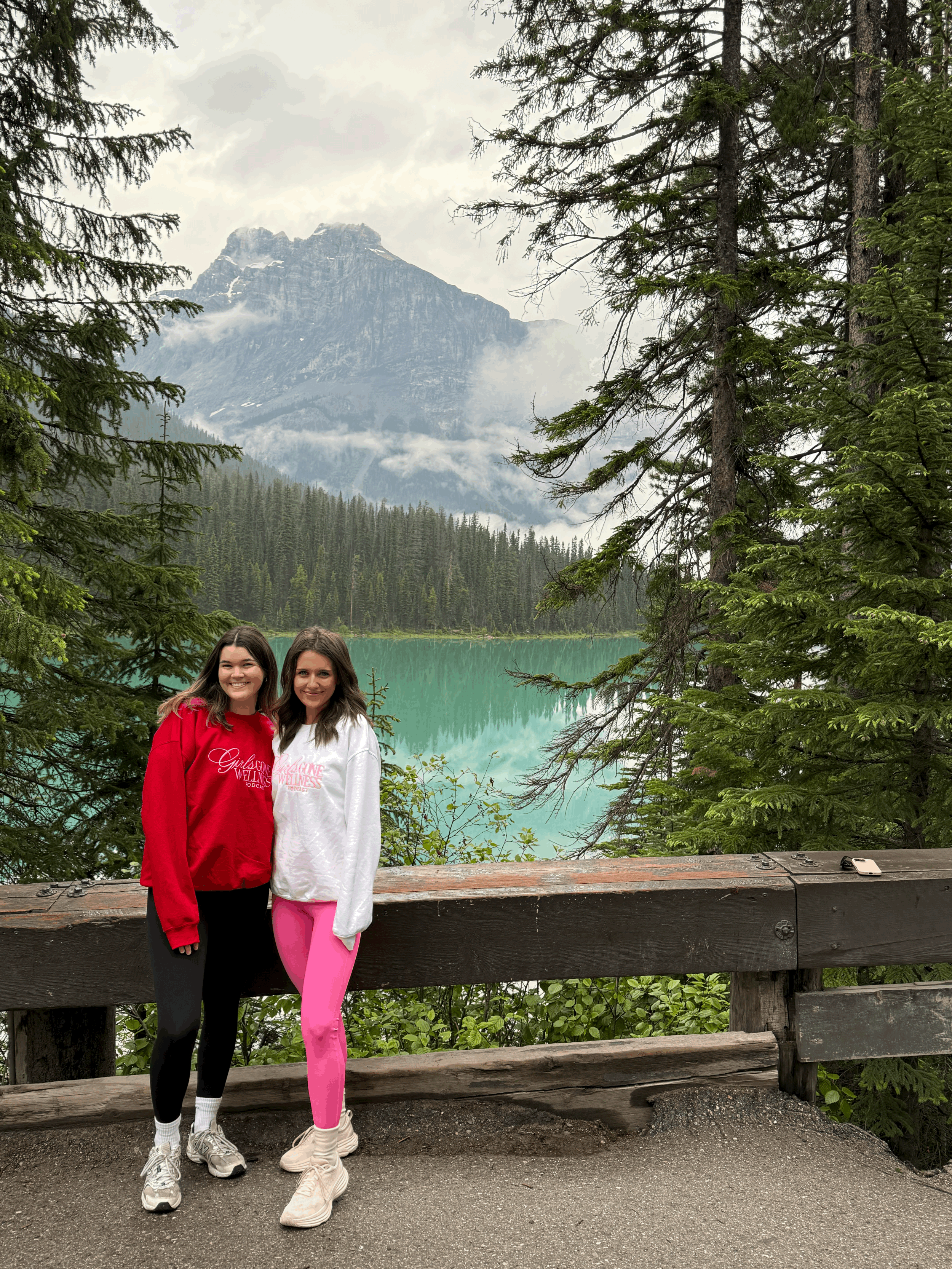 2 girls wearing white and red wellness crewnecks and sweaters