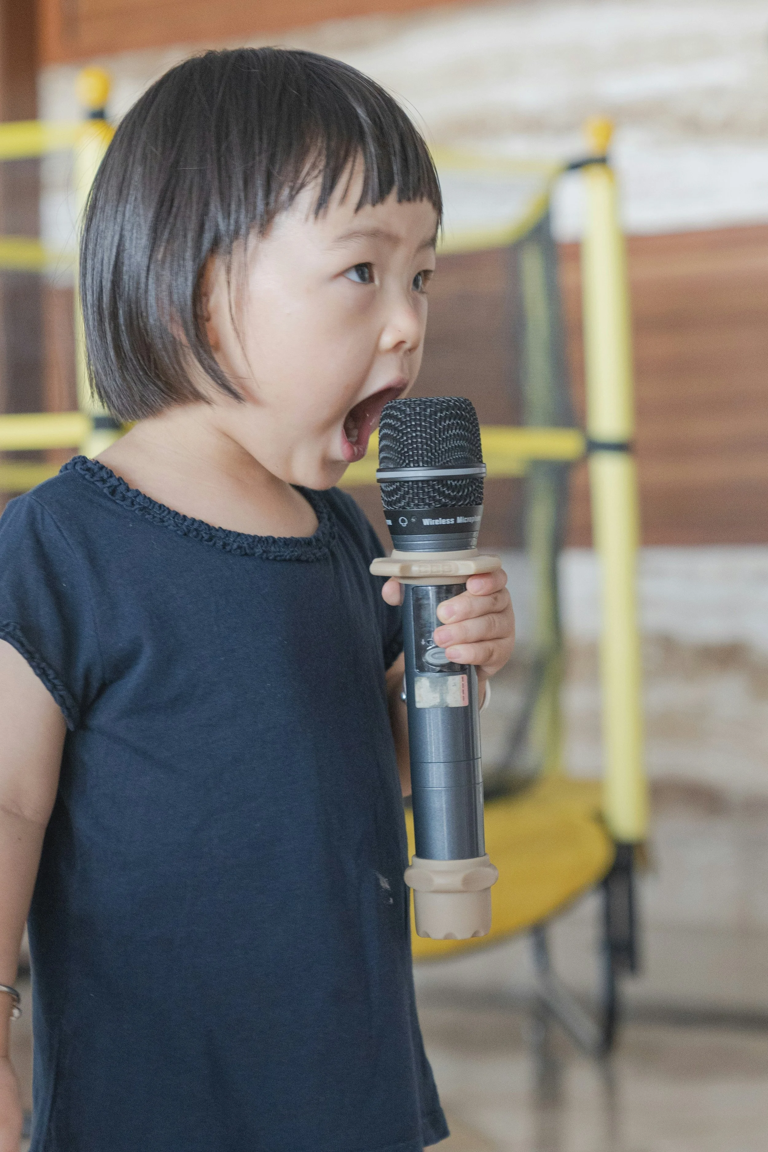 Young girl speaking into a microphone.