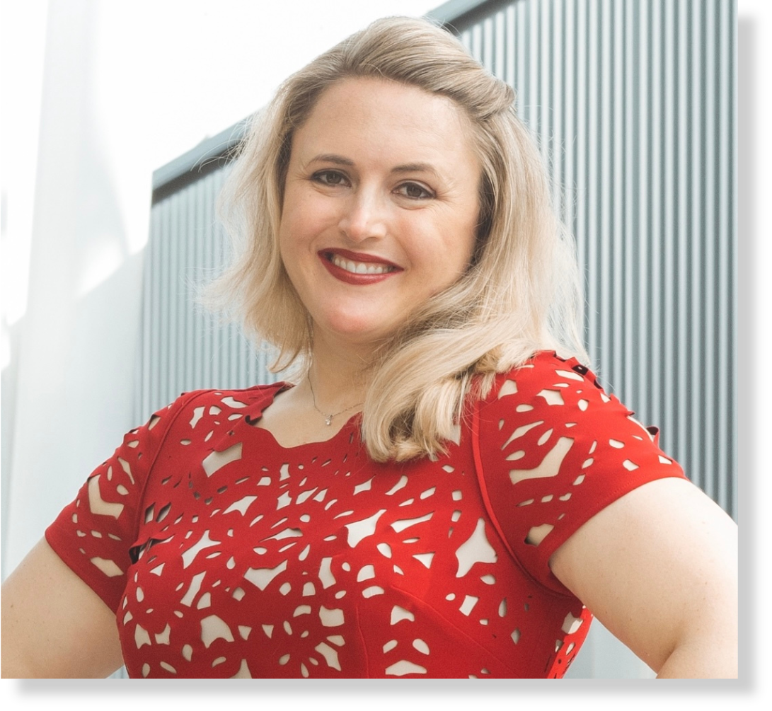 Portrait of Jena Miller, global innovation and automation leader, smiling confidently in a red dress. Represents her creative and human-centered approach to leadership, technology, and transformation.