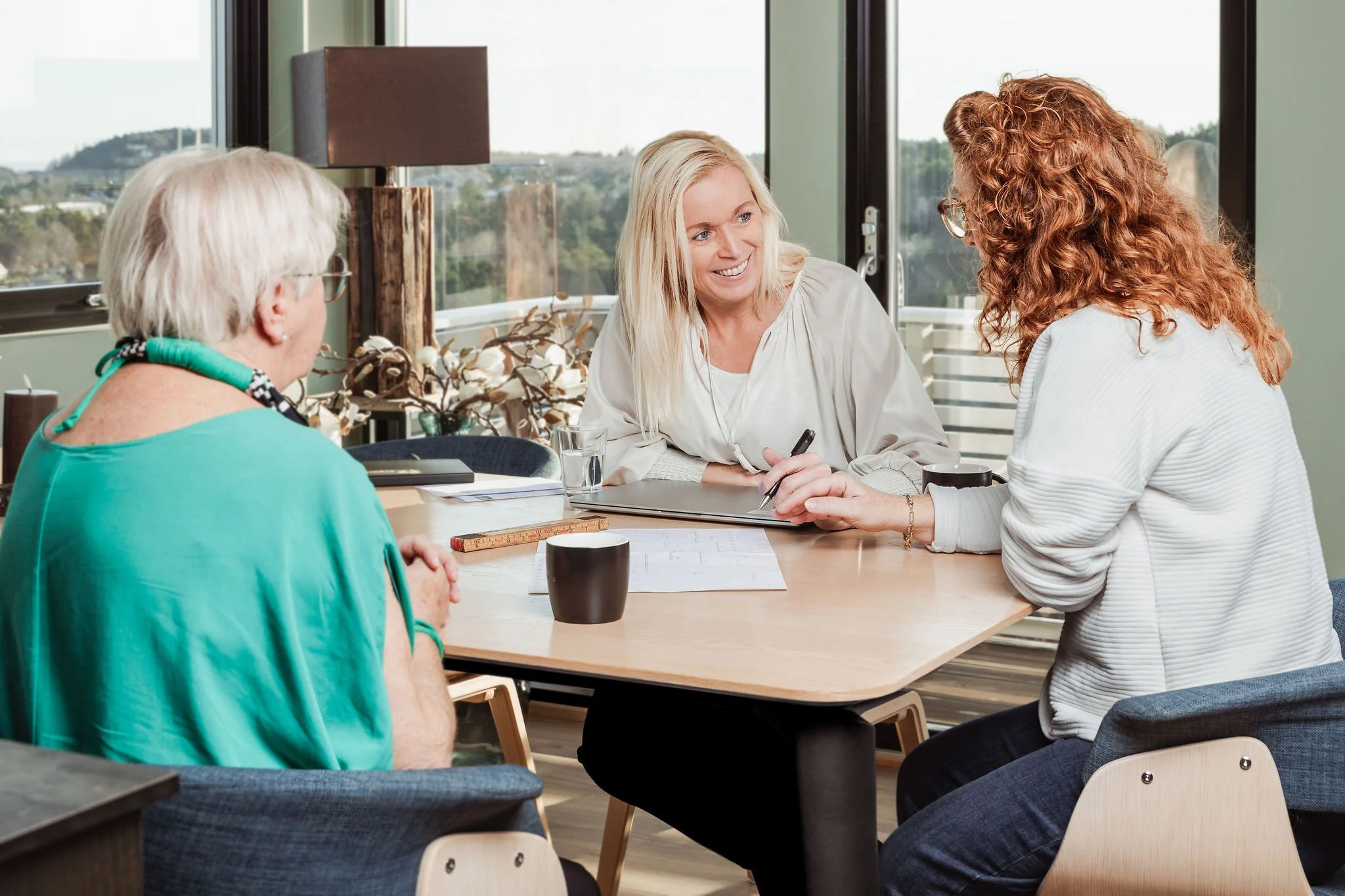 Ergoterapeut i samtale med eldre og pårørende for å gi tidlig, faglig og personlig oppfølging som supplement til kommunale tjenester