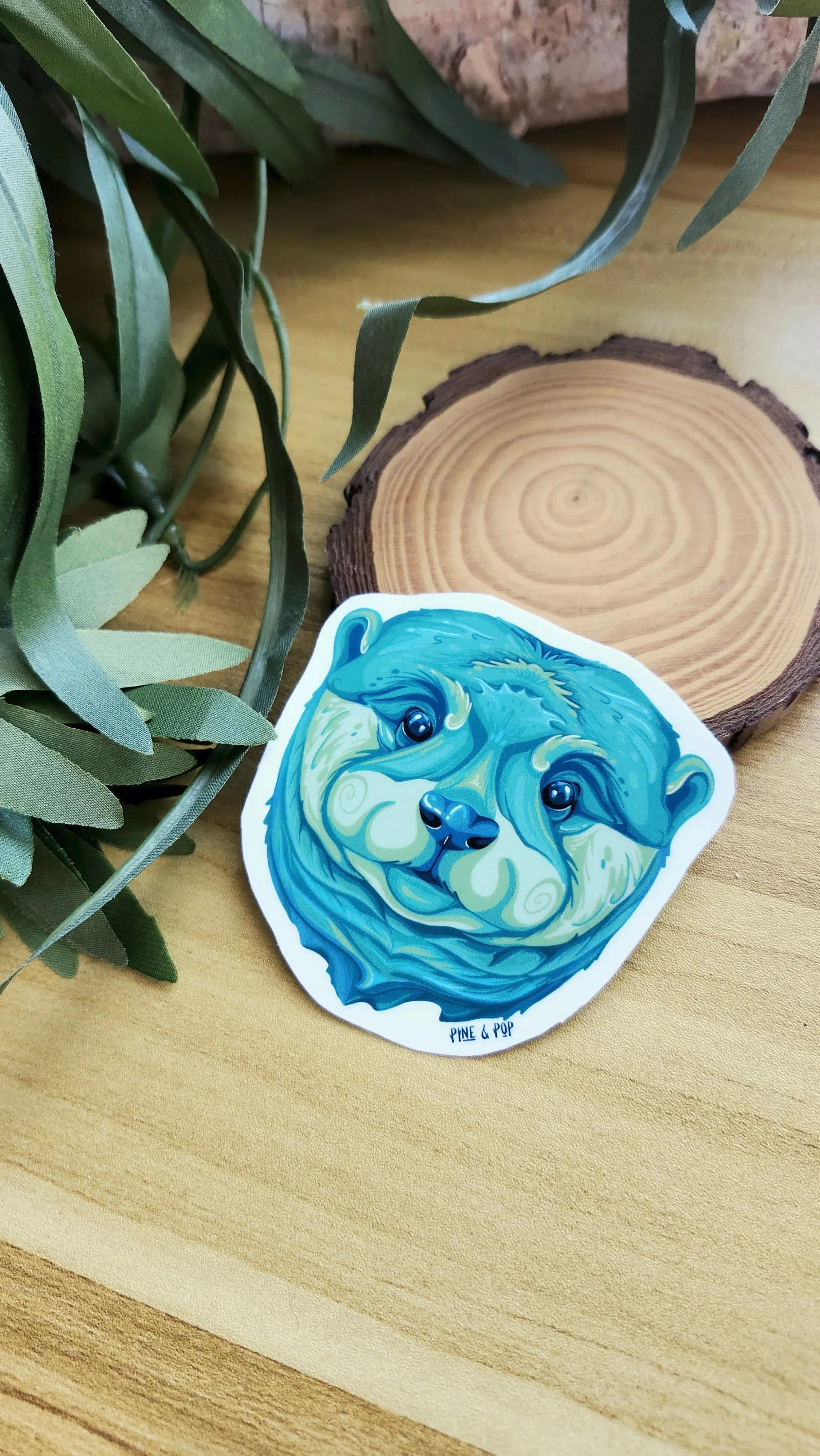 otter face sticker made with green, blue, and teal colors