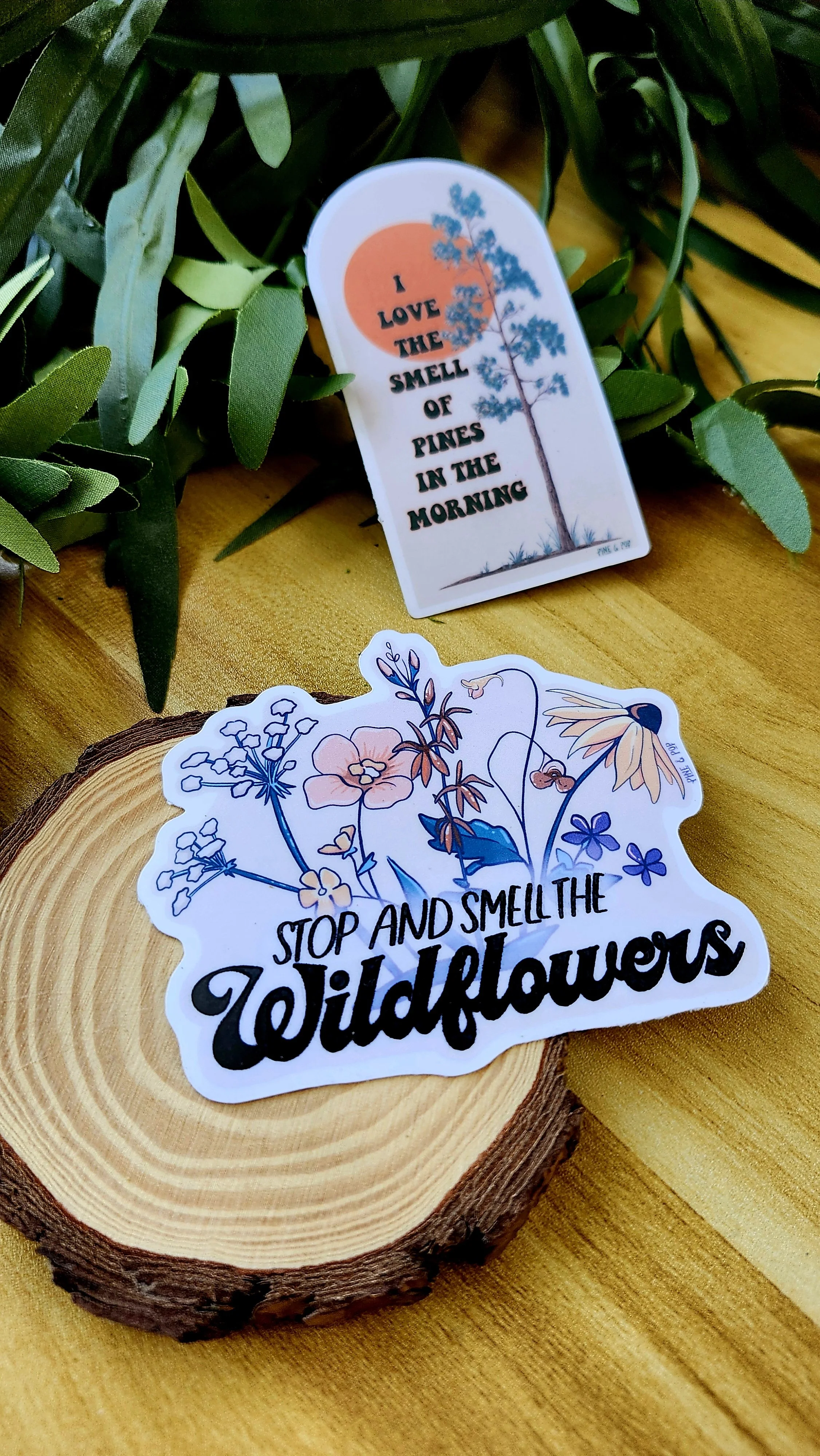 2 stickers laying on a wooden table