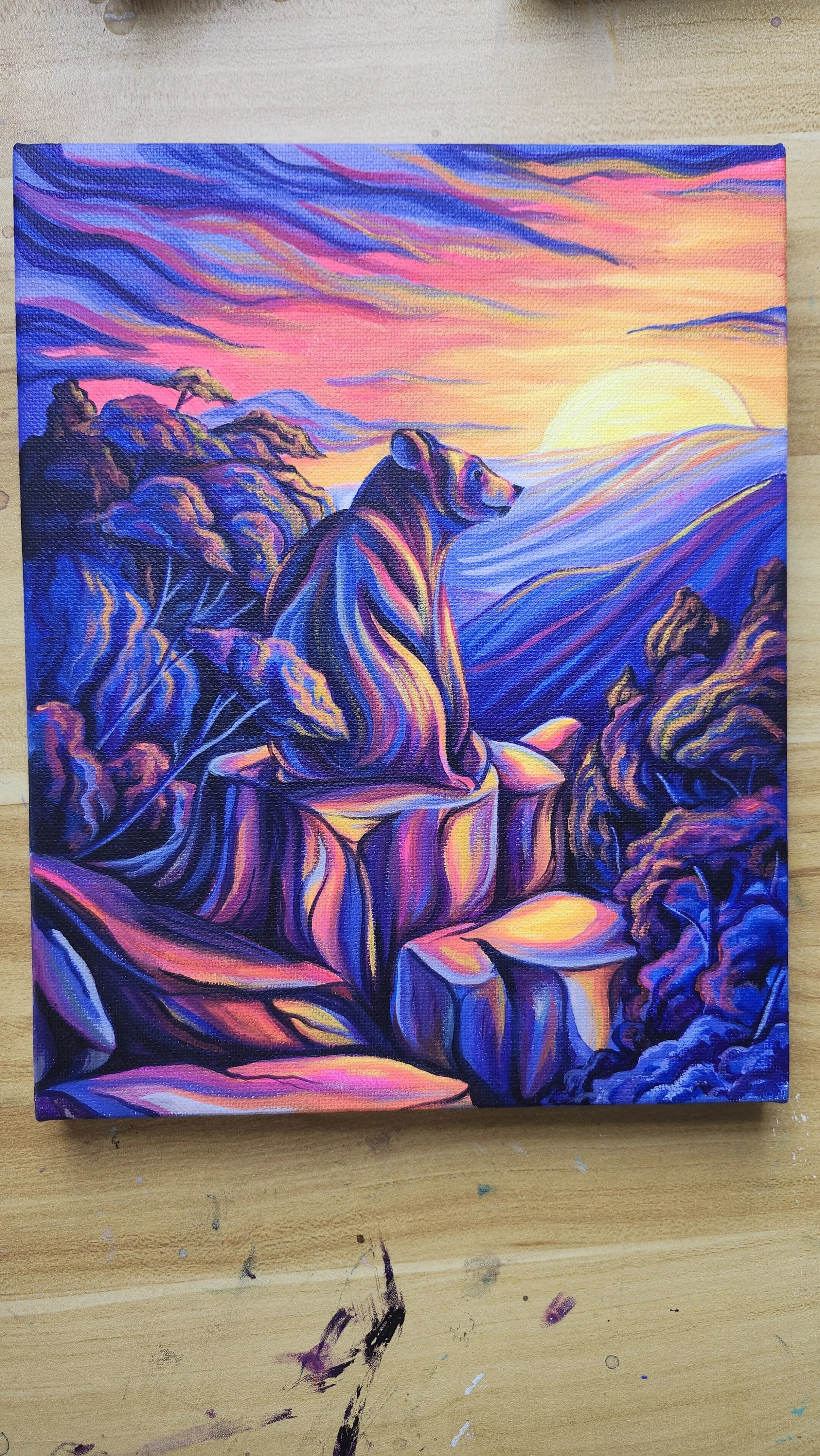 full portrait of colorful sunset hike view with bear sitting at the summit looking out at the view  