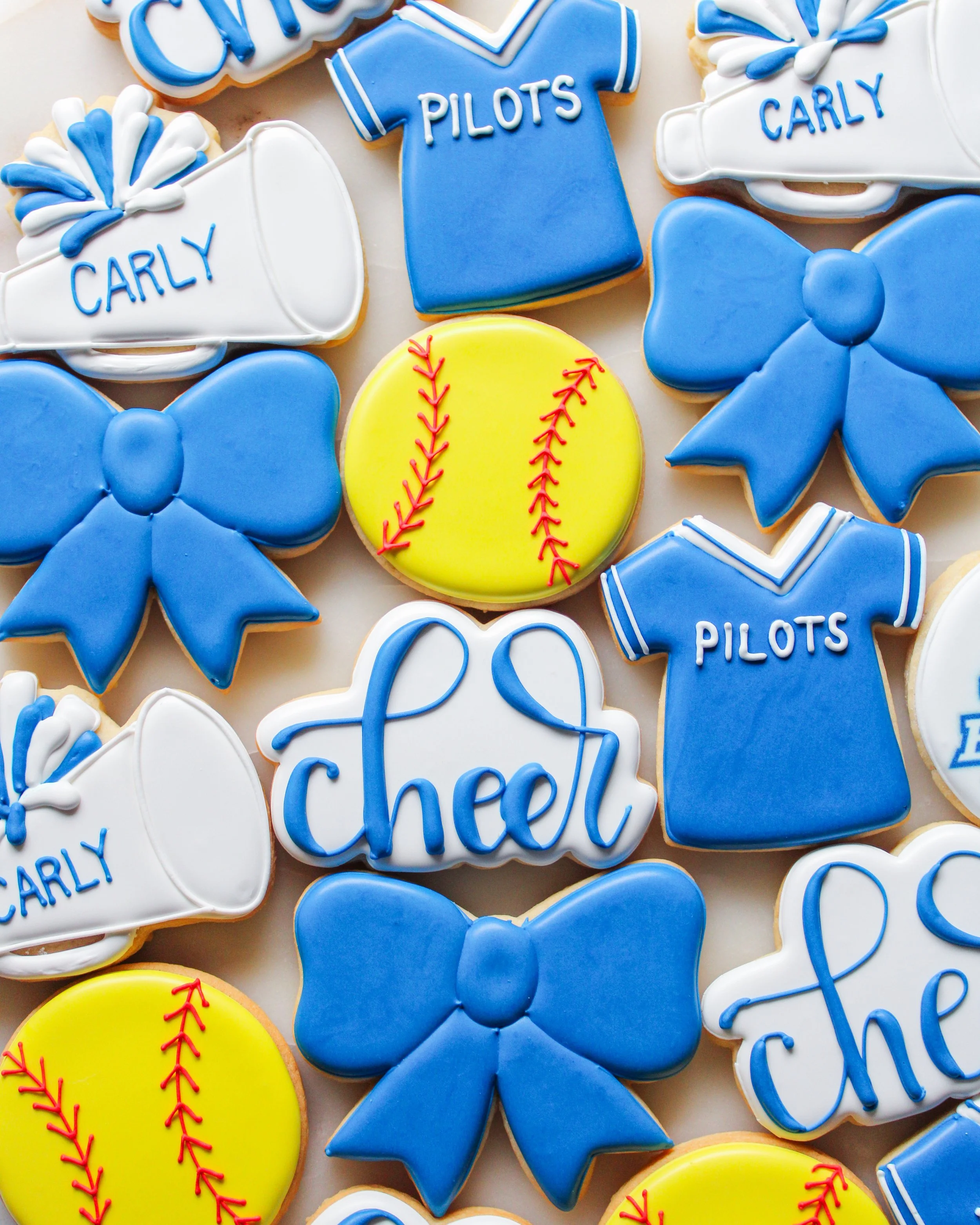decorated sugar cookies with cheer and softball designs  