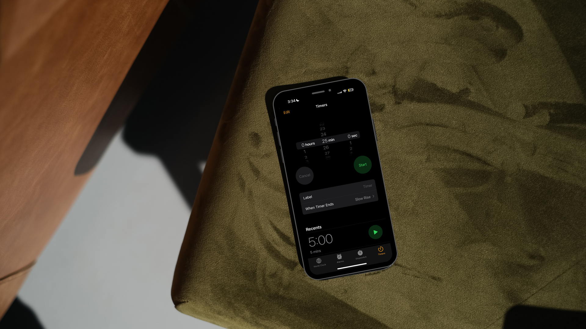 Smartphone showing an active timer set for five minutes on a textured green surface.
