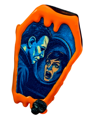 A coffin cake pop with an image of Michael Myers and Laurie Strode inspired by the film Halloween, surrounded by a neon orange chocolate drip.