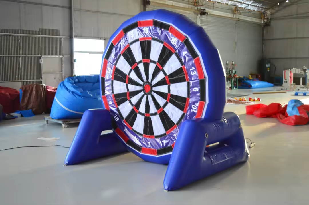 Inflatable dartboard set up indoors with a blue frame and black, white, red, and blue sections.