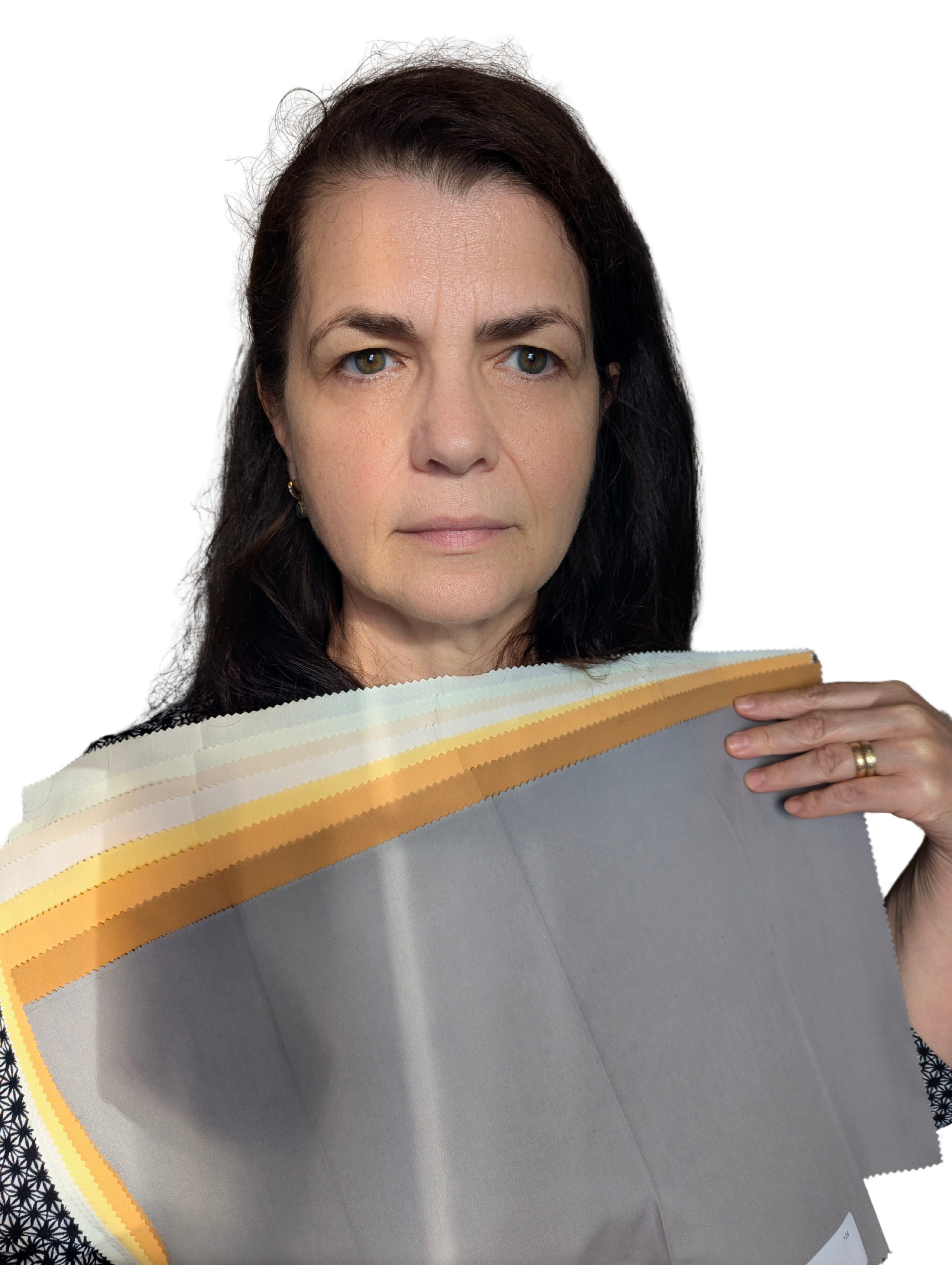 A woman with dark hair holding a fabric sample with a gold-striped border.