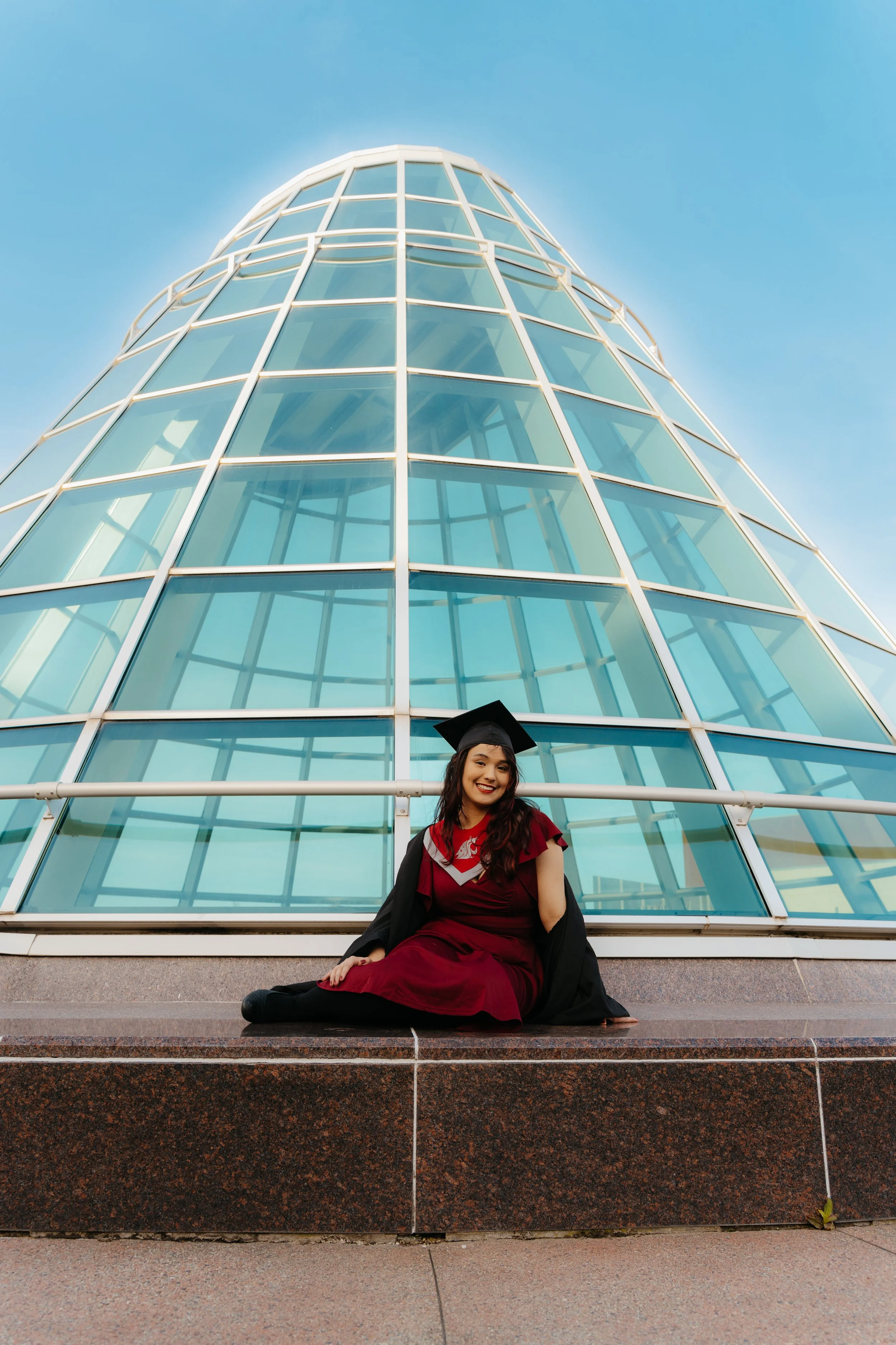 Women in marron sitting in glass structure