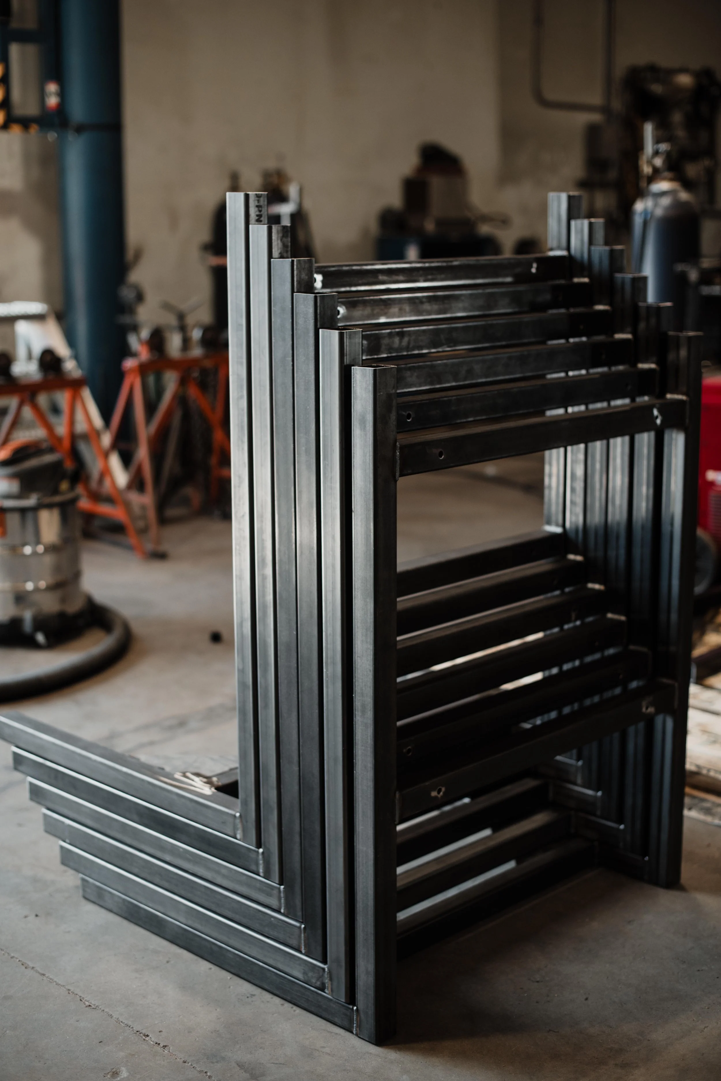 Stacked metal frames in an industrial workshop.