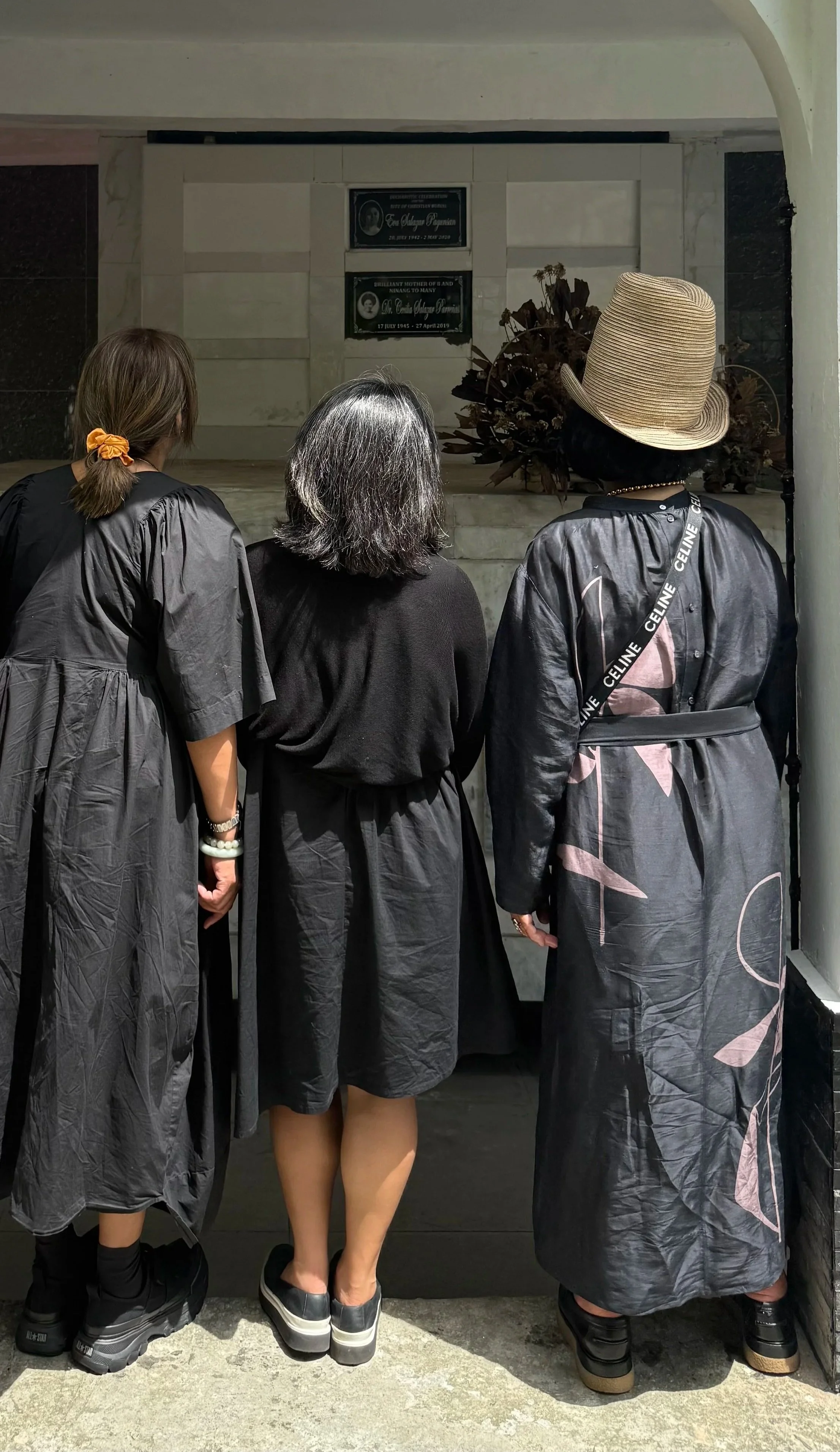 Three sisters at their mother’s burial site in her family mausoleum.