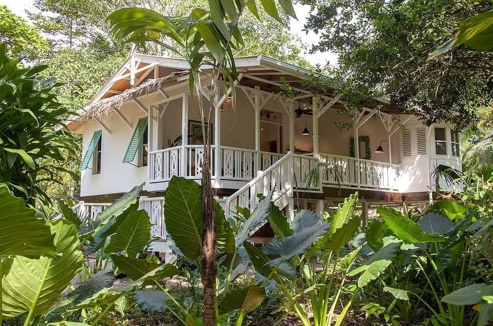 Tropical bungalow-style villa at Hotel Aguas Claras, a member of the Cayuga Collection, surrounded by lush rainforest vegetation near Puerto Viejo on Costa Rica’s Caribbean coast.