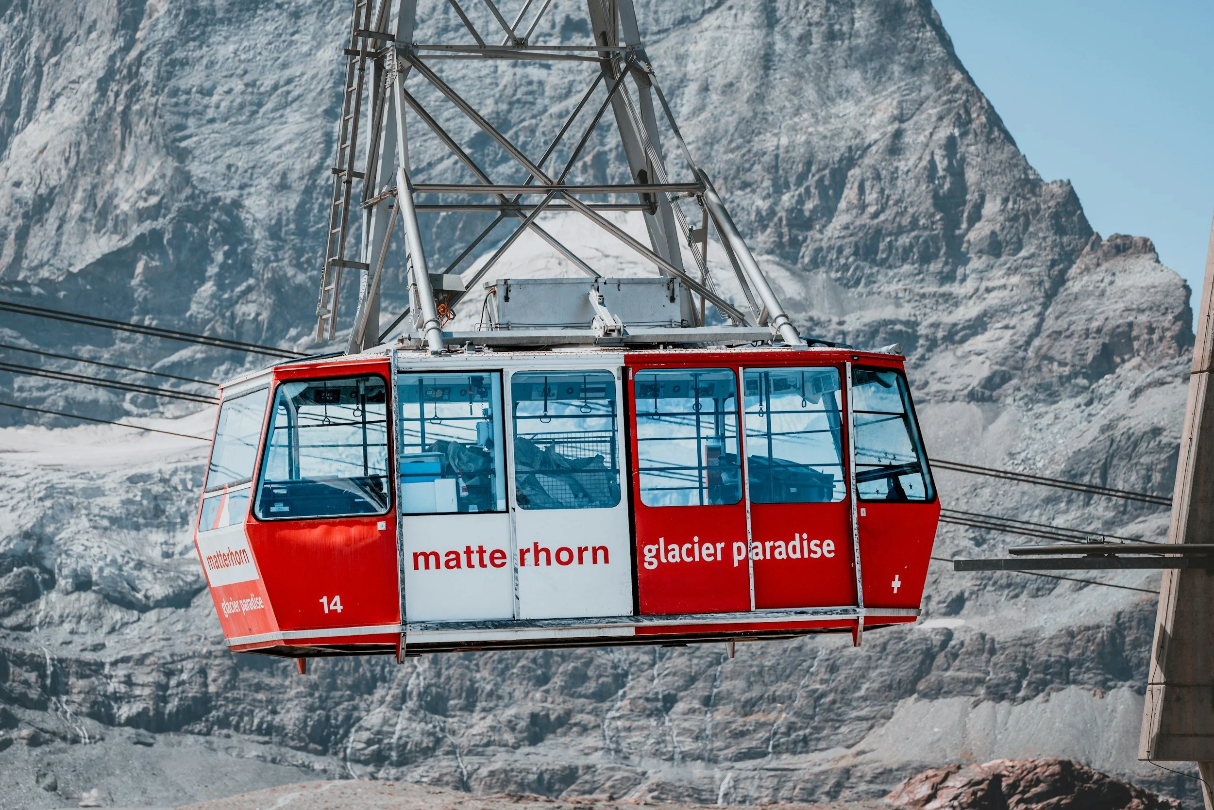 Matterhorn Glacier Paradise cable car suspended over alpine mountains with rugged peaks in Zermatt, Switzerland