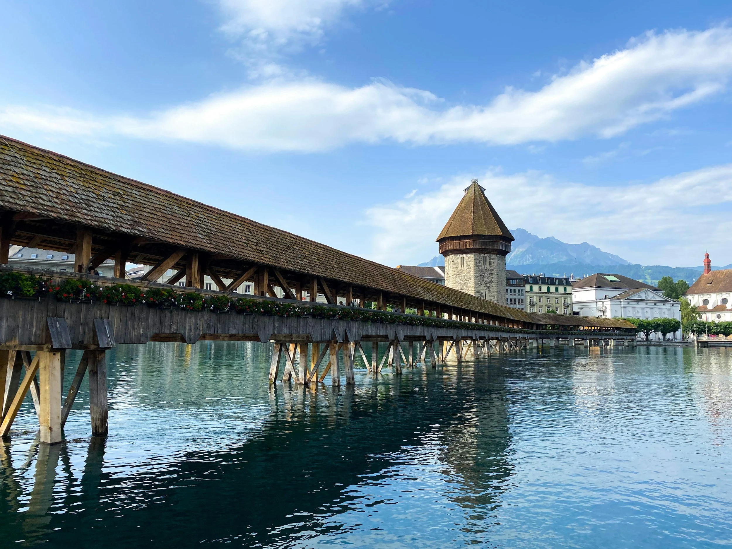 Chapel Bridge in Lucerne with its historic wooden structure and water tower spanning the Reuss River in Switzerland