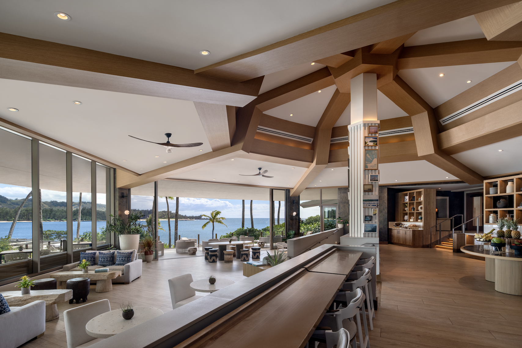 Club Lounge at The Ritz-Carlton Turtle Bay with floor-to-ceiling ocean views, warm wood beams, and relaxed coastal seating.