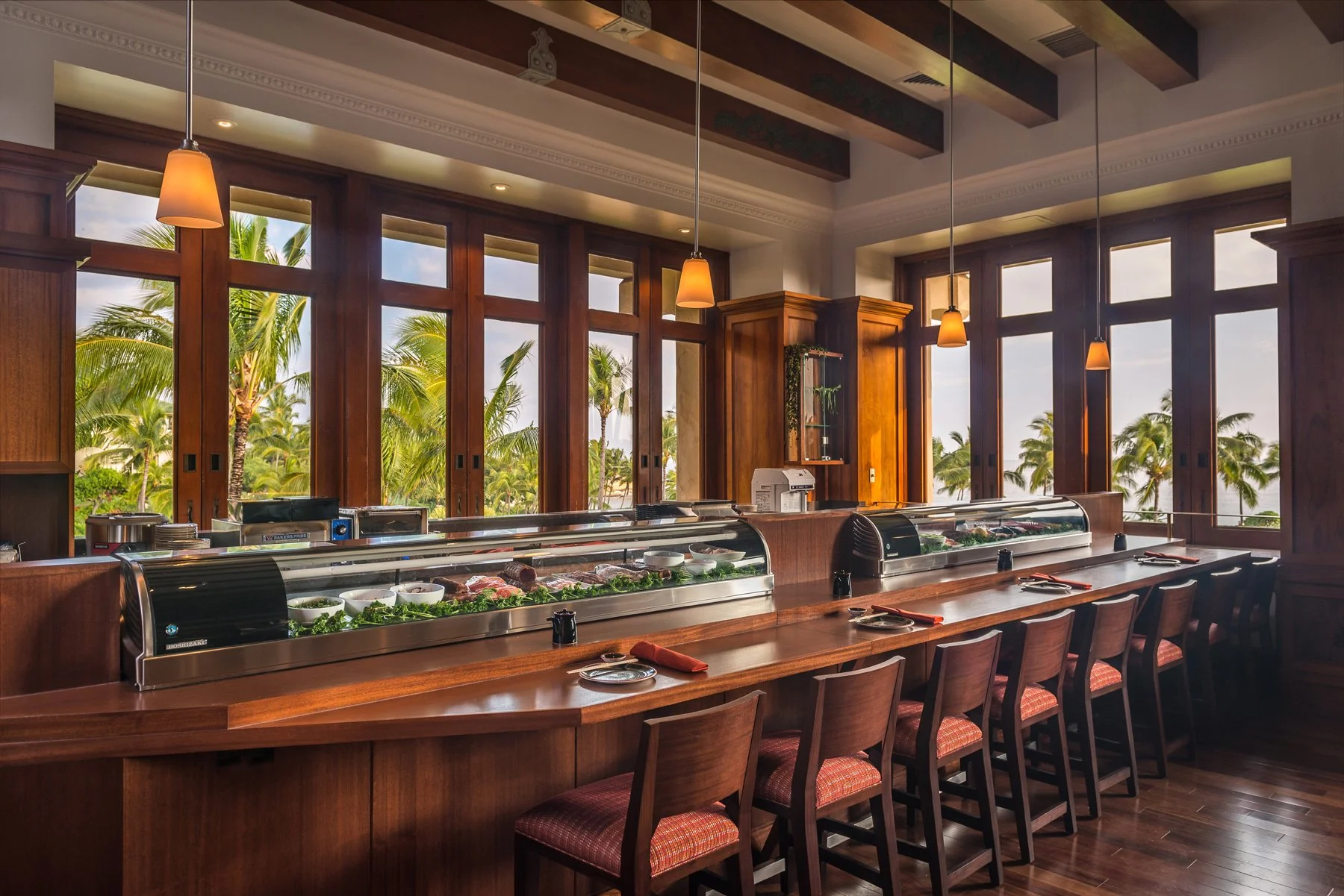 Stevenson’s Sushi & Spirits restaurant at Grand Hyatt Kauai Resort & Spa featuring a sushi bar, warm wood interiors, and tropical garden views.