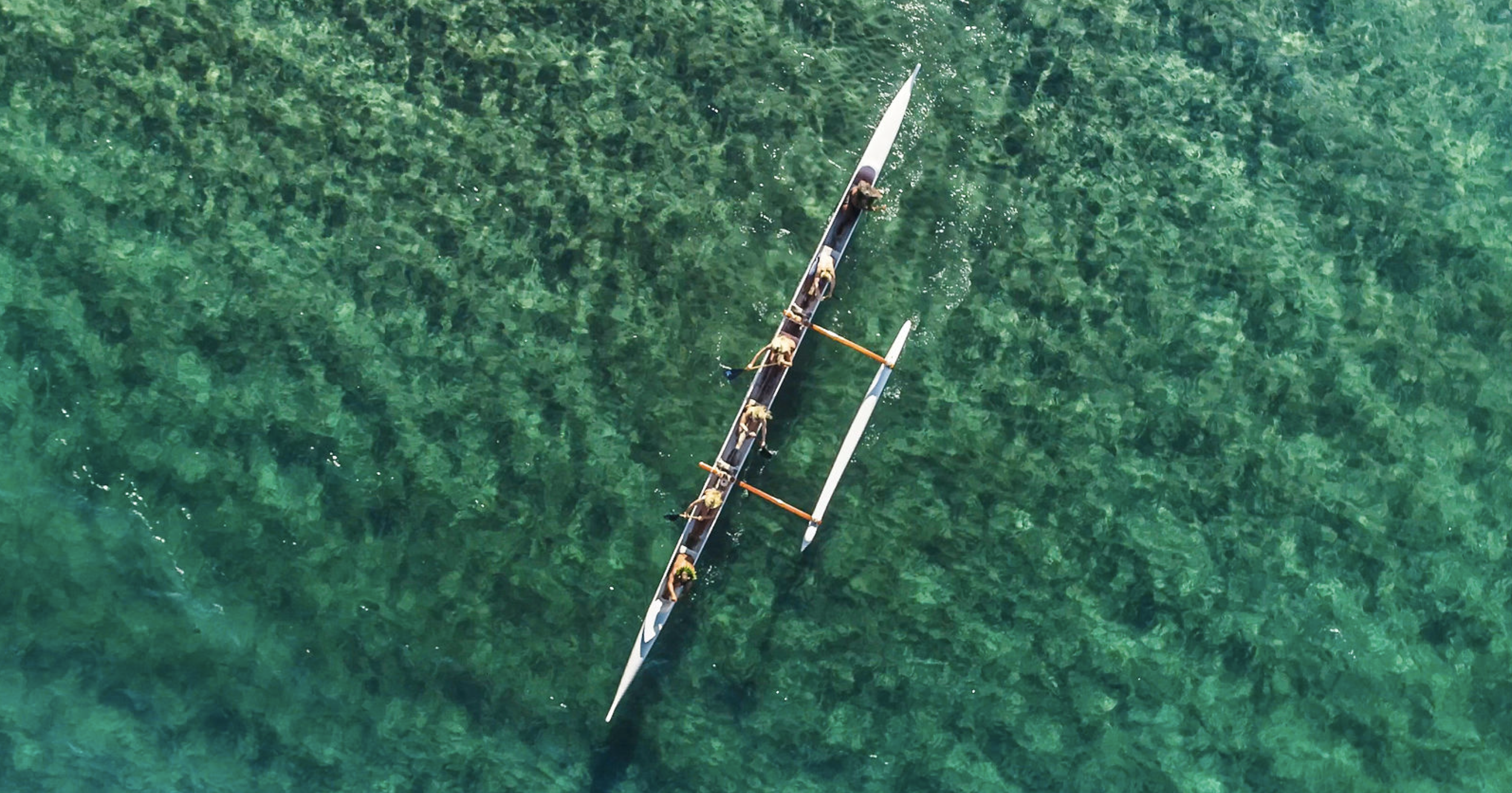 Outrigger canoe experience in crystal-clear waters at Fairmont Kea Lani Maui