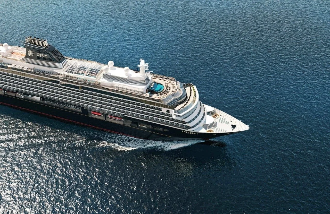 Luxury Explora cruise ship sailing through open ocean with expansive decks and onboard pool visible from above