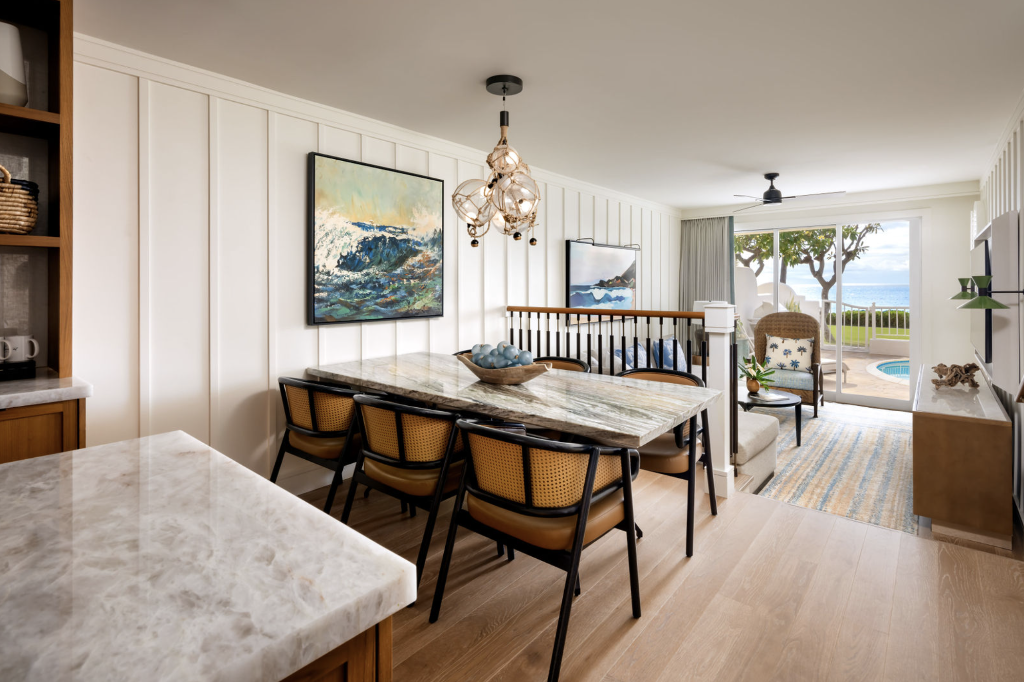 Luxury villa living room with dining area, ocean view lanai, and tropical decor at Fairmont Kea Lani Maui